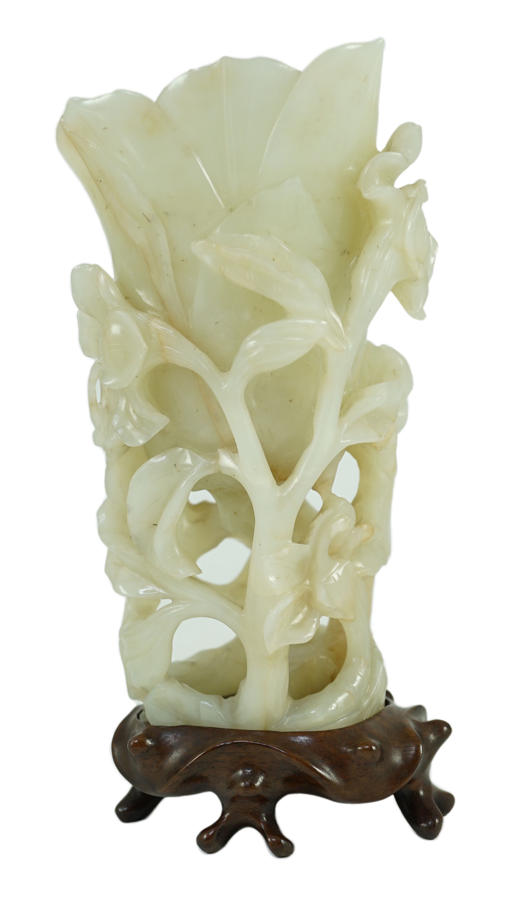 A large Chinese pale celadon jade ‘magnolia’ cup, 17th/18th century 17.5cm high excluding wood stand                                                                                                                        