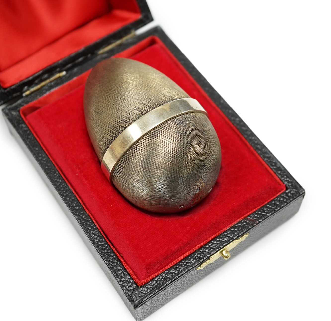 An Elizabeth II Stuart Devlin silver gilt surprise egg, opening to reveal a hedgehog, no. 152, London, 1978, 7cm, in original box.                                                                                          