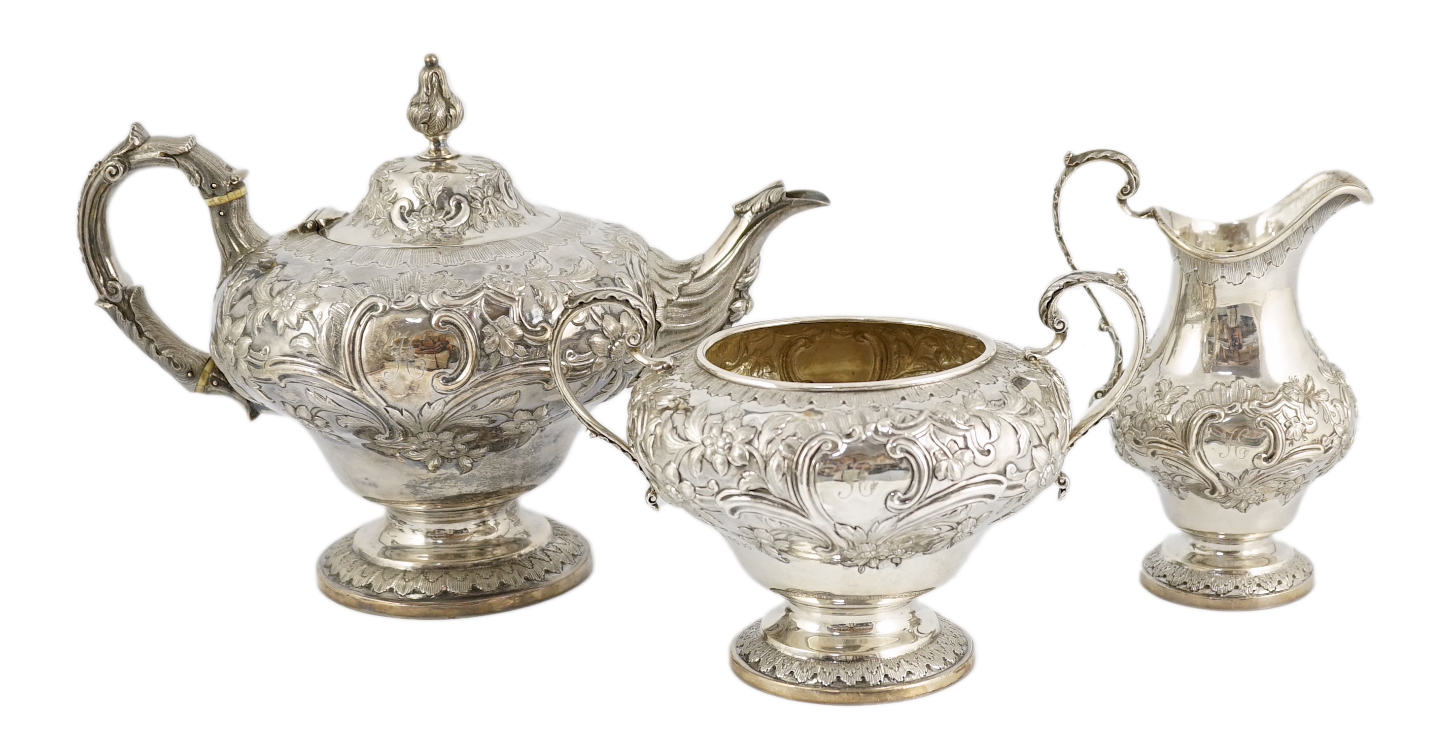 A Victorian silver inverted pear shaped three piece tea set by John Wellby                                                                                                                                                  