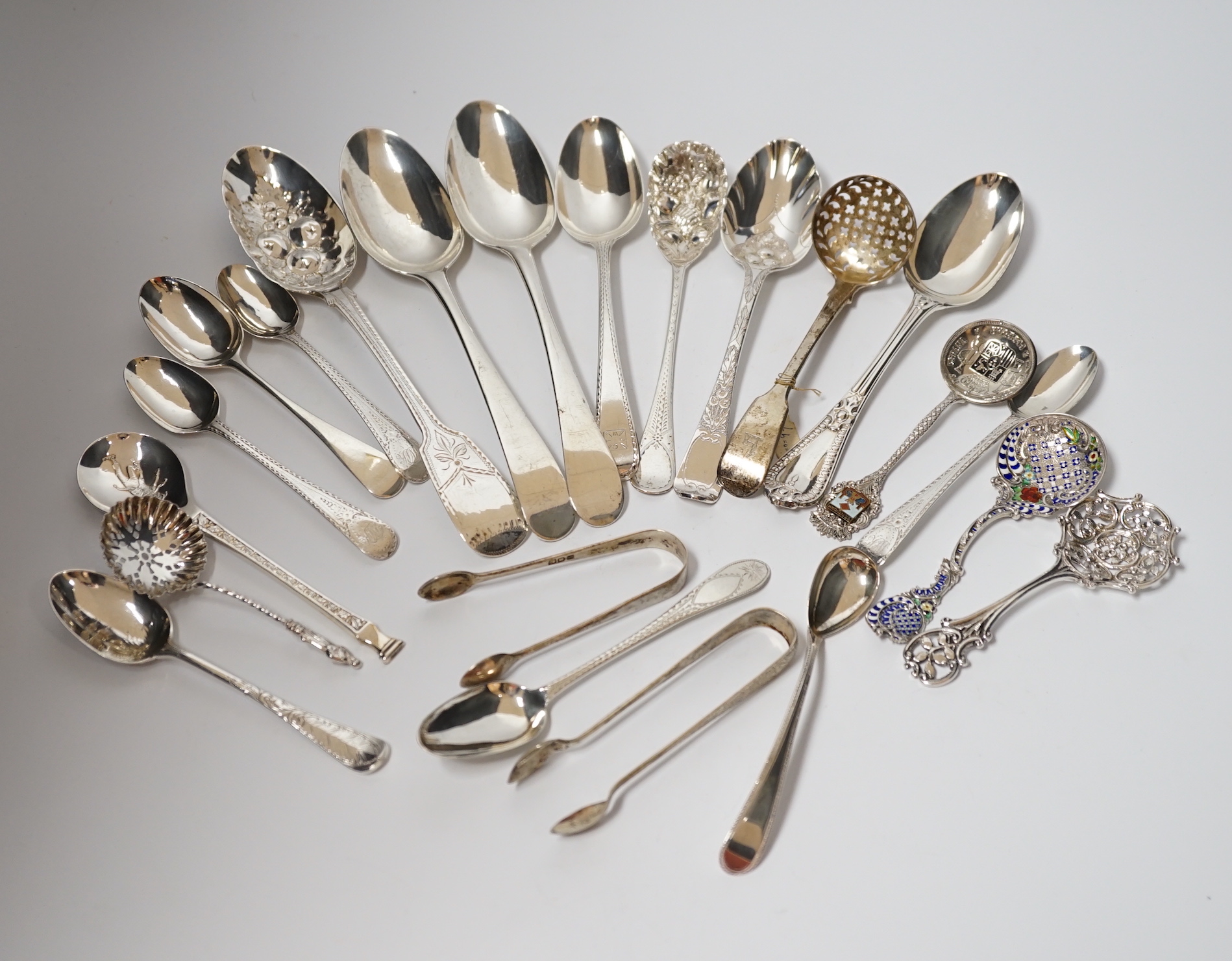 A quantity of assorted 19th century and later silver flatware, various dates and makers including base mark table spoons, berry spoons, sifter spoon etc. together with an Scandinavian 925 and enamelled spoon and a plated