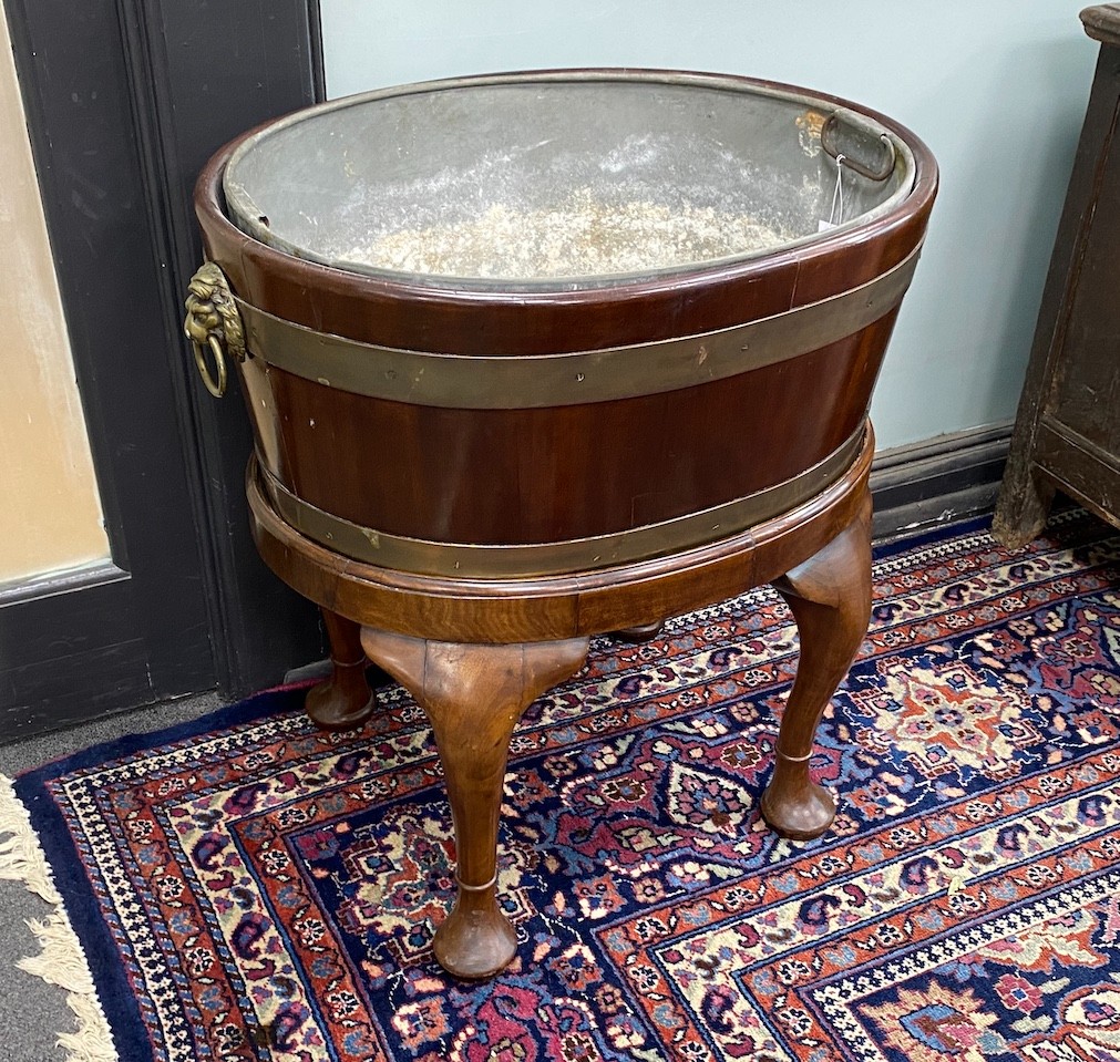 A George III style oval brass bound mahogany wine cooler on stand, width 60cm, depth 44cm, height 66cm                                                                                                                      