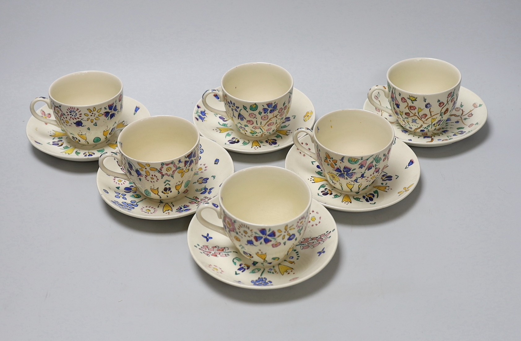 Jessie Marion King. A set of six floral teacups and saucers                                                                                                                                                                 