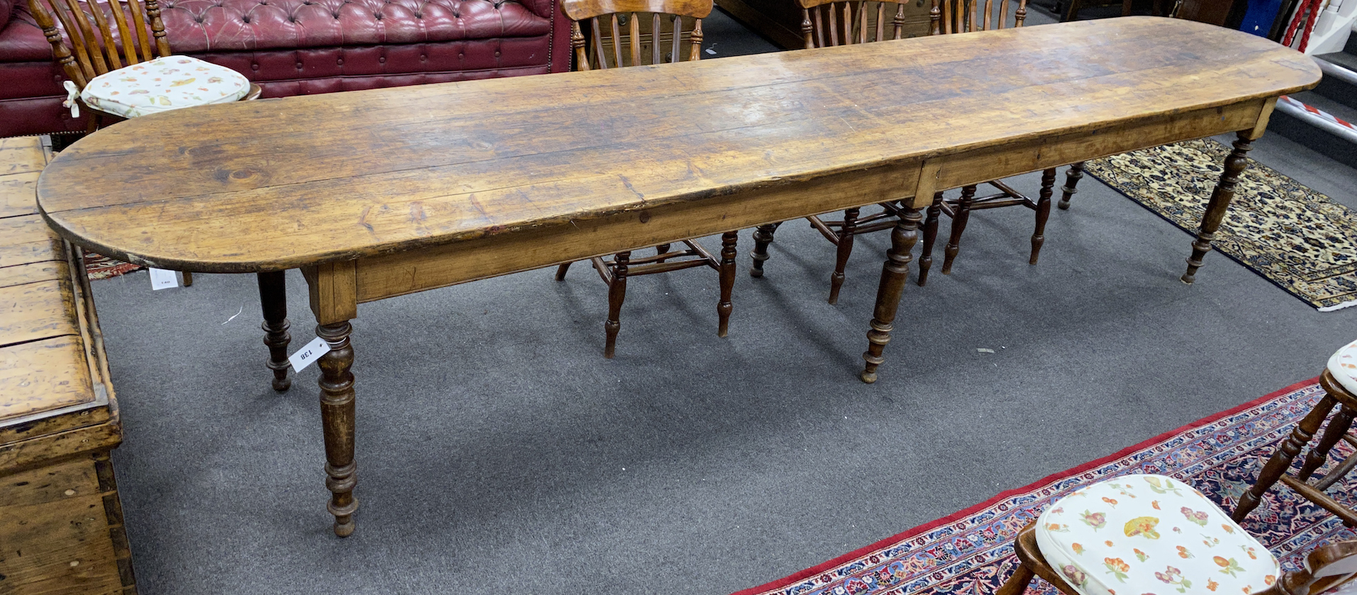 A 19th century French elm and fruitwood farmhouse table the triple planked top on six turned tapered legs, length 370cm, depth 67cm, height 73cm                                                                            