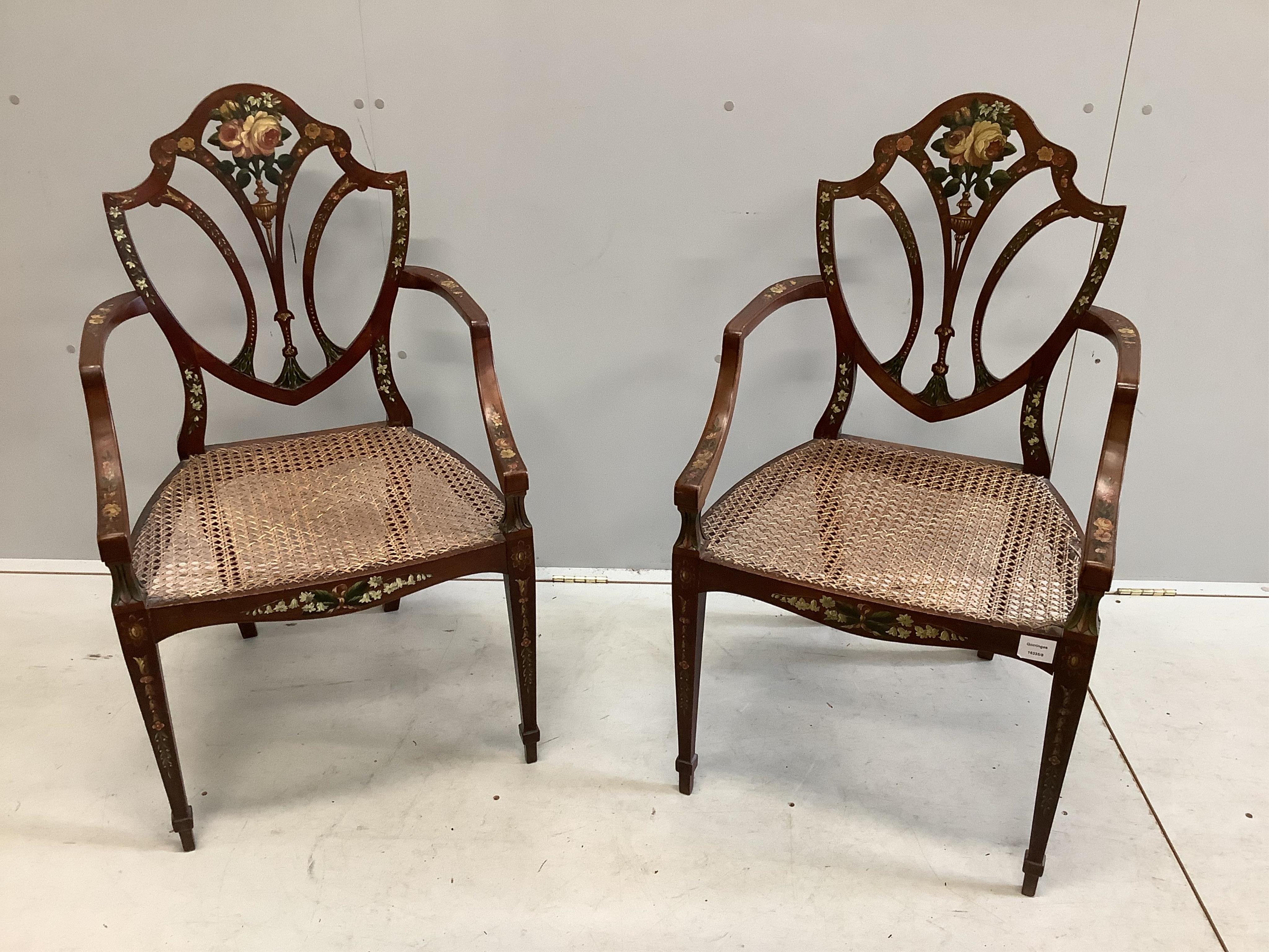 A pair of Edwardian Sheraton Revival painted satinwood elbow chairs, width 51cm, depth 48cm, height 96cm. Condition - fair                                                                                                  