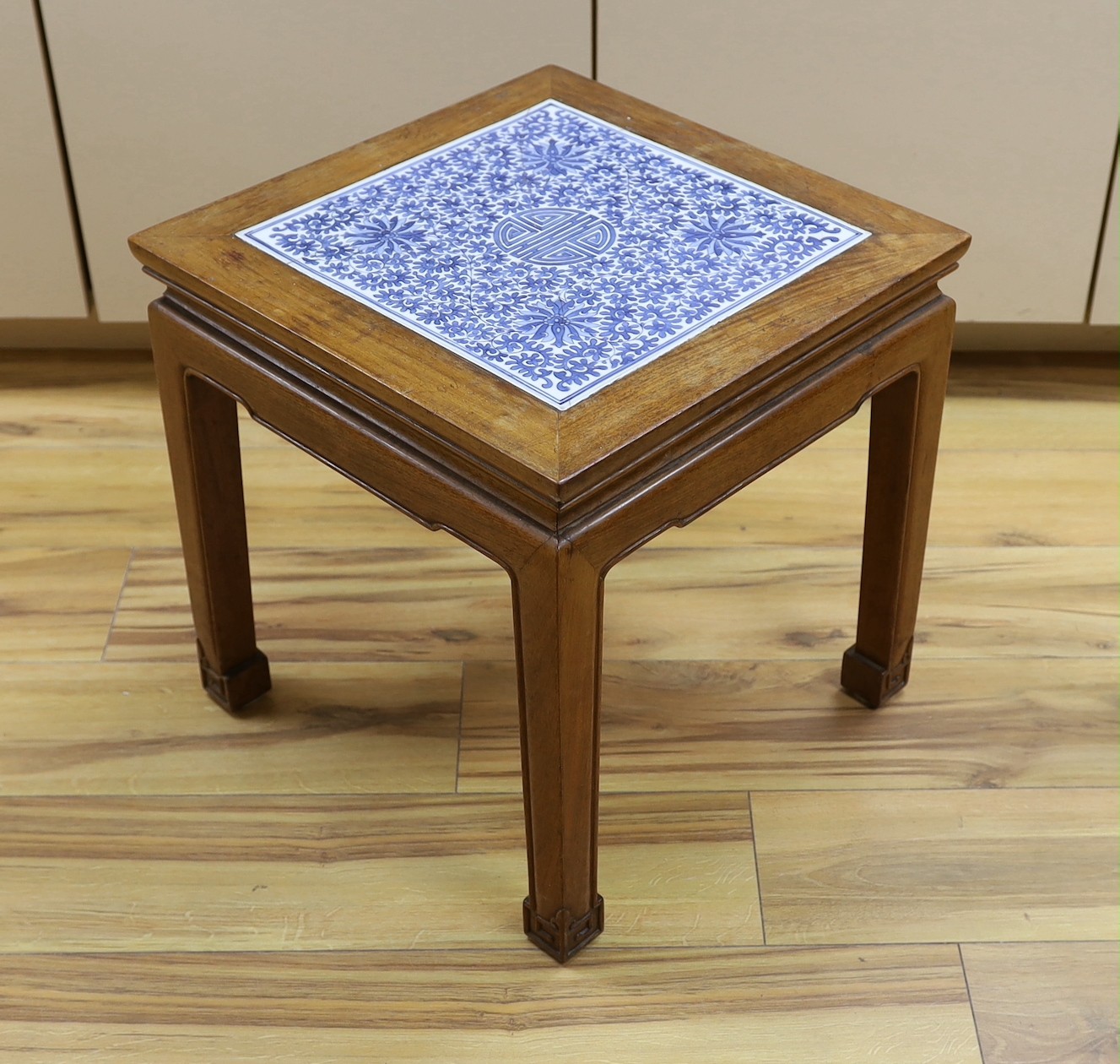 A Chinese hardwood and blue and white porcelain inset table, 42cms square                                                                                                                                                   