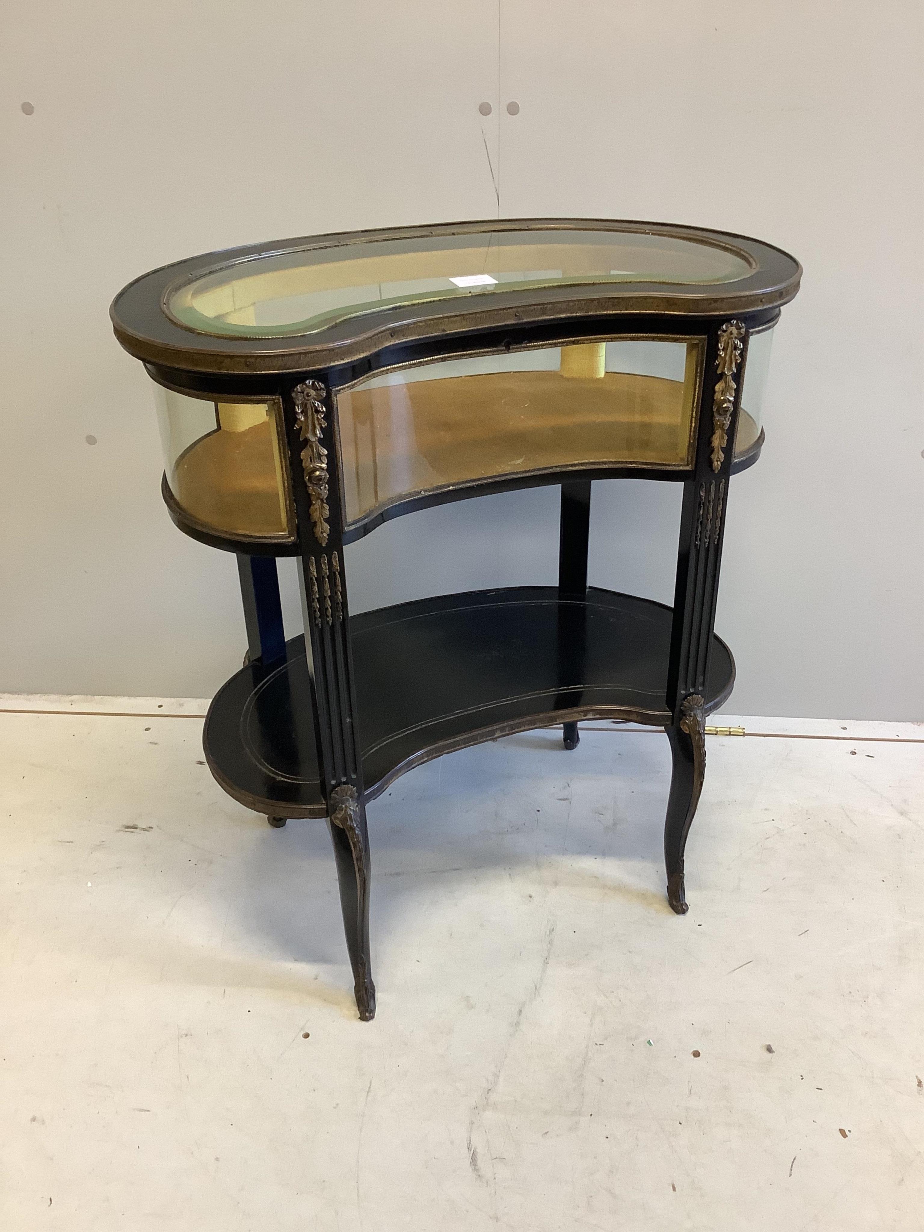 A late 19th century gilt metal mounted ebonised kidney shaped bijouterie cabinet, width 69cm, depth 42cm, height 78cm. Condition - fair                                                                                     