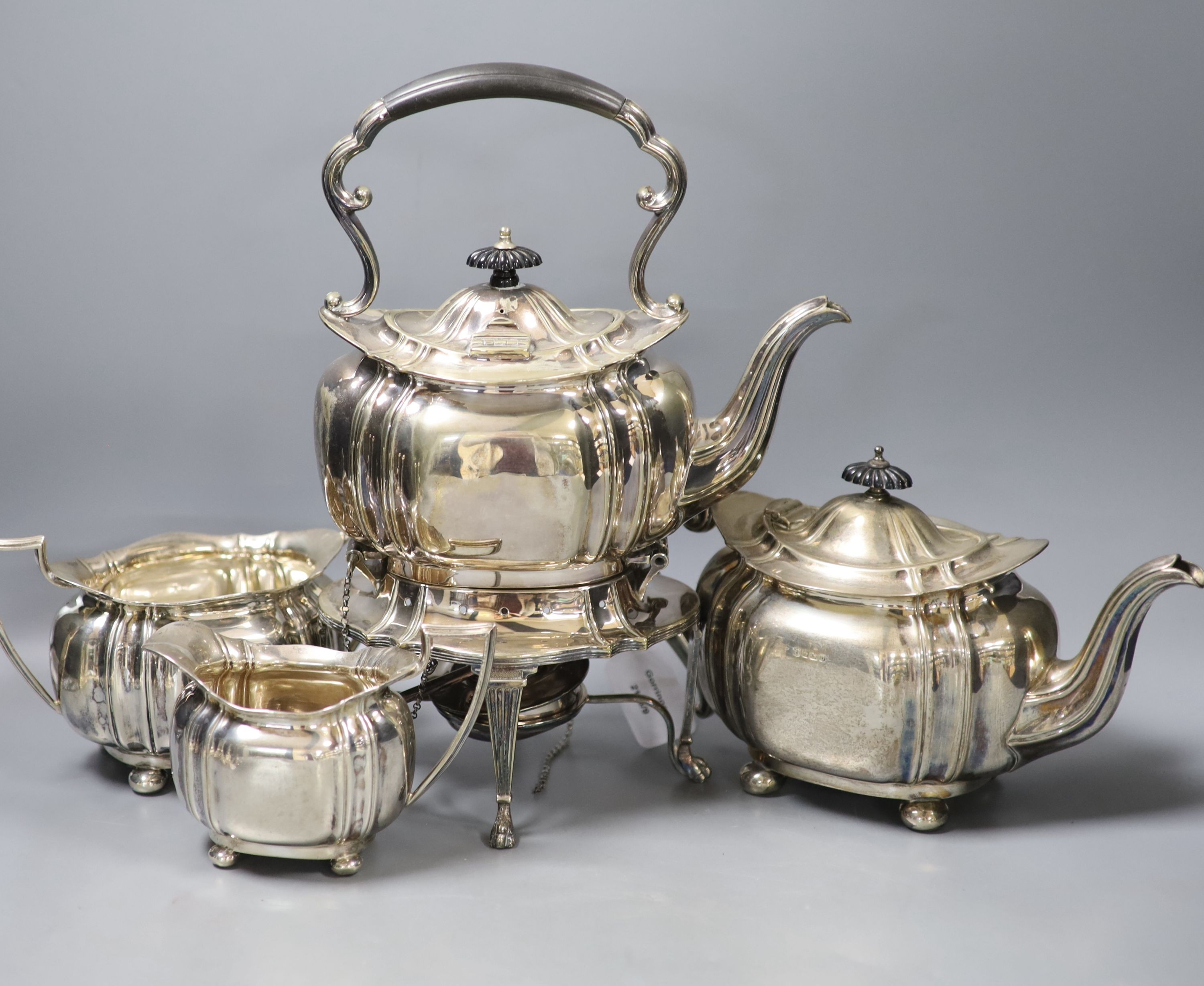 A George V silver three piece tea set, Cooper Brothers & Sons, Sheffield, 1913, gross 42oz, together with a similar plated tea kettle on stand with burner.                                                                 