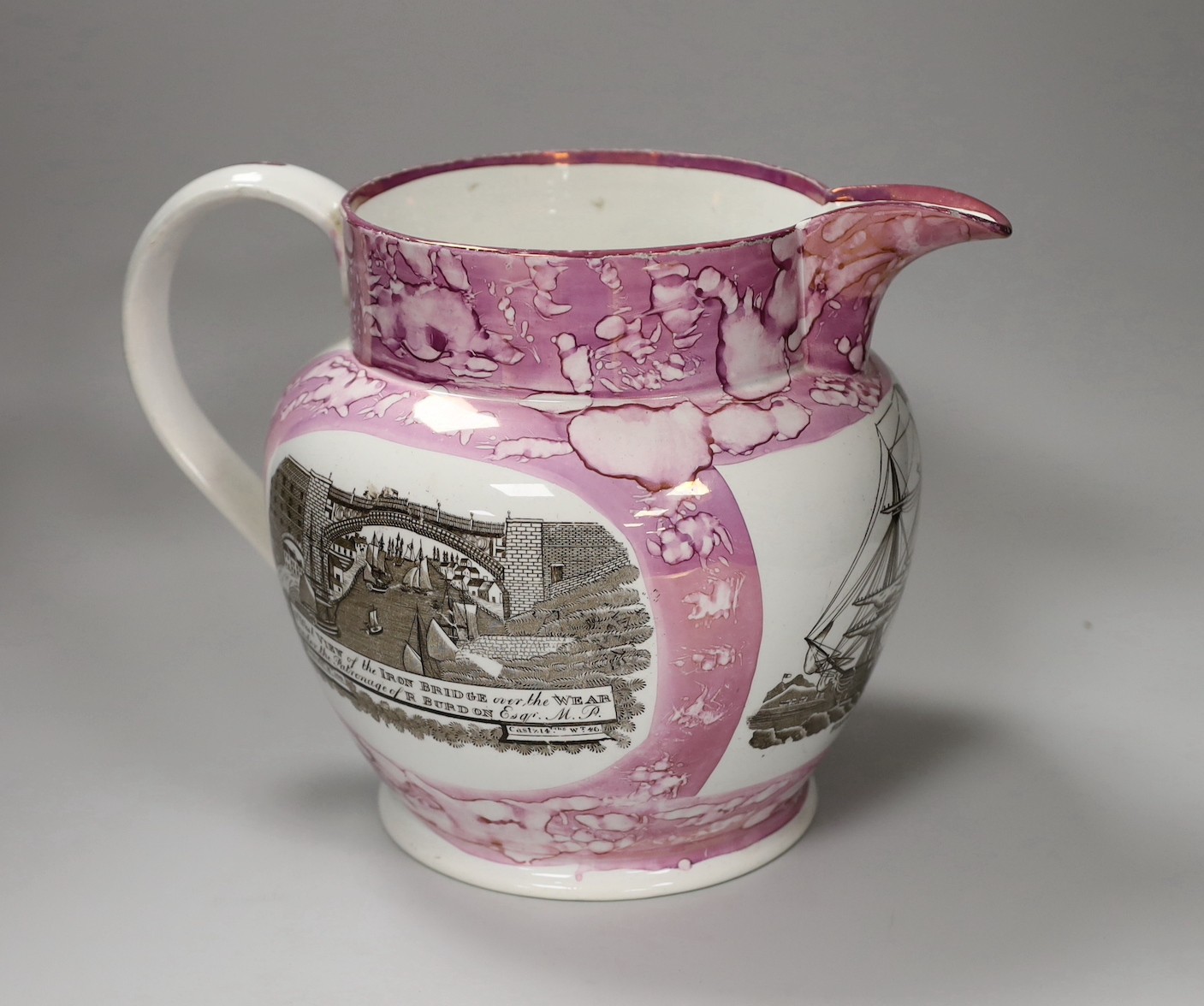 A Sunderland pink lustre ‘Northumberland 74’ and ‘ View of the iron bridge over the Wear’ jug, early 19th century, 23cm                                                                                                     