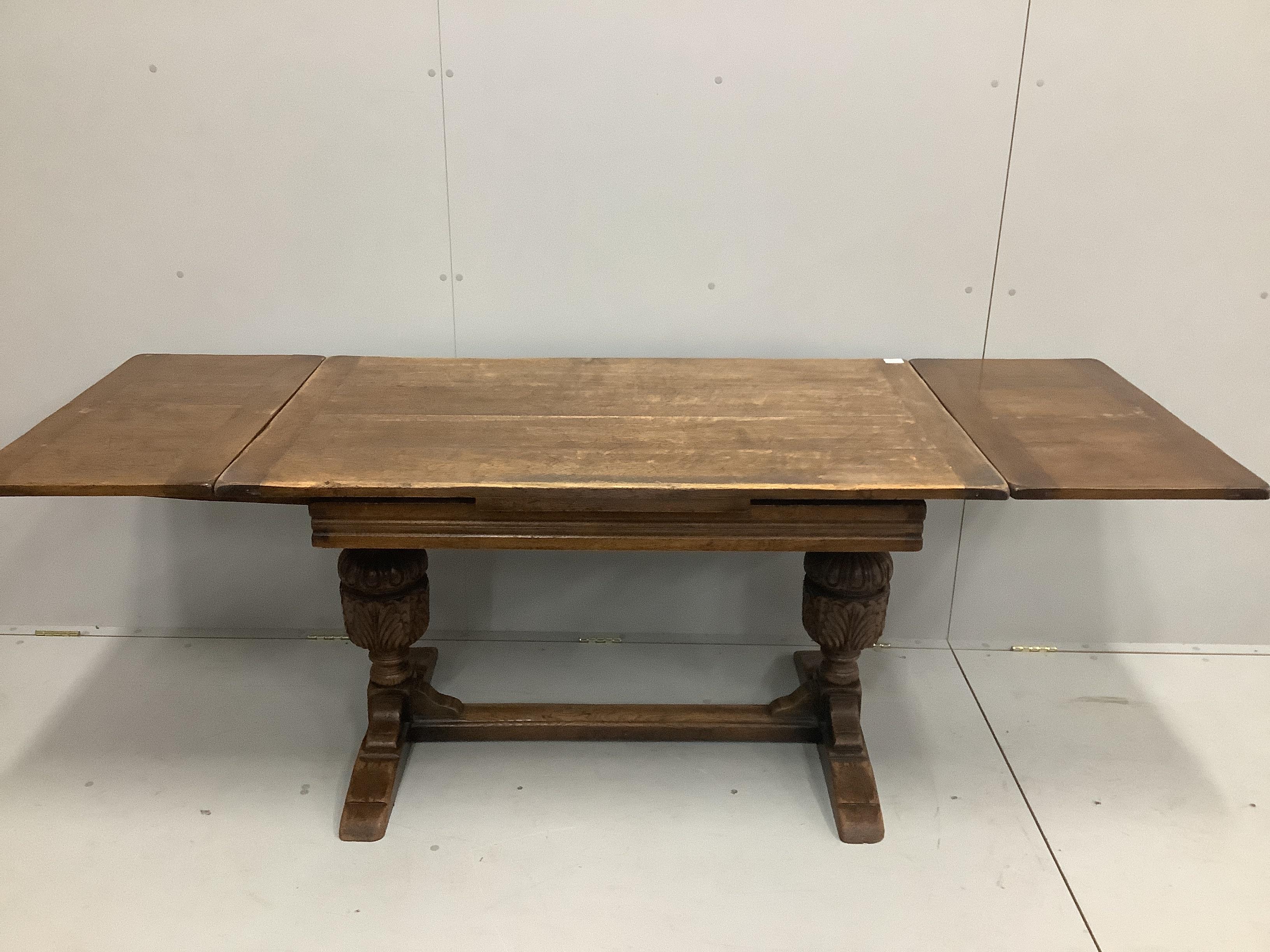 An 18th century style rectangular oak draw leaf dining table, length 210cm extended, width 77cm, height 75cm together with six oak dining chairs, two with arms                                                             
