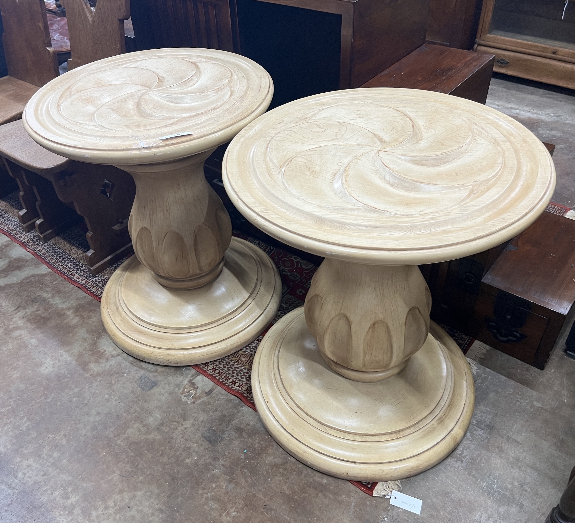 A pair of contemporary American circular carved wood centre tables, diameter 64cm, height 75cm                                                                                                                              