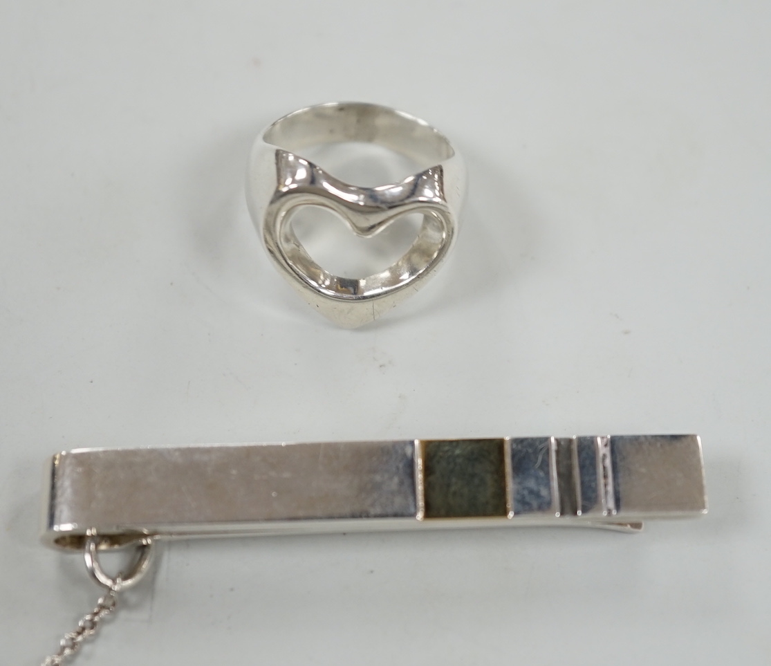 A Georg Jensen sterling pierced heart ring, size N and a Georg Jensen two colour sterling tie clip, design no. 152A, 58mm.                                                                                                  