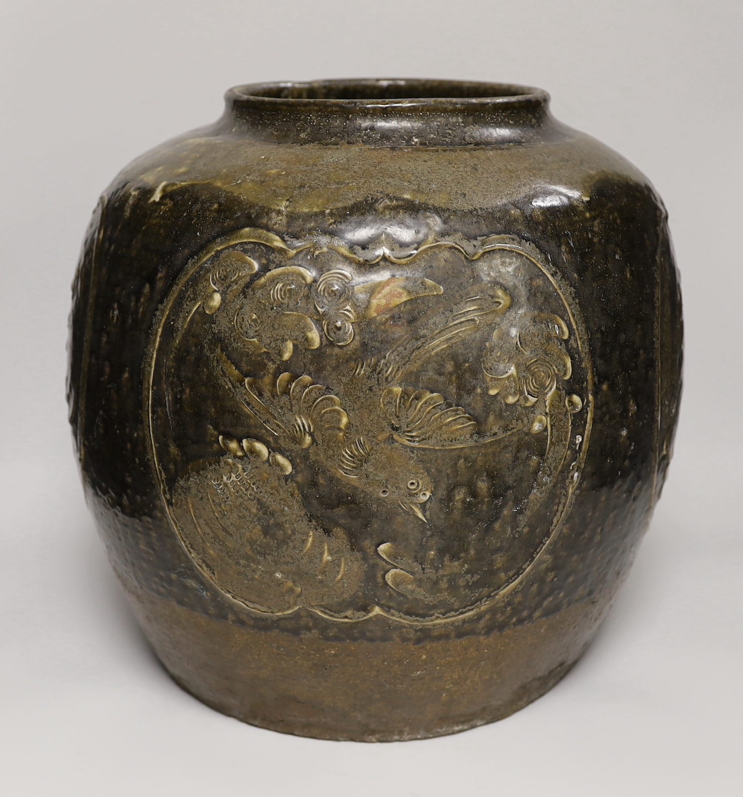 A large Chinese stoneware ovoid jar, decorated in relief with birds and flowers, possibly 19th century, 36cm high                                                                                                           