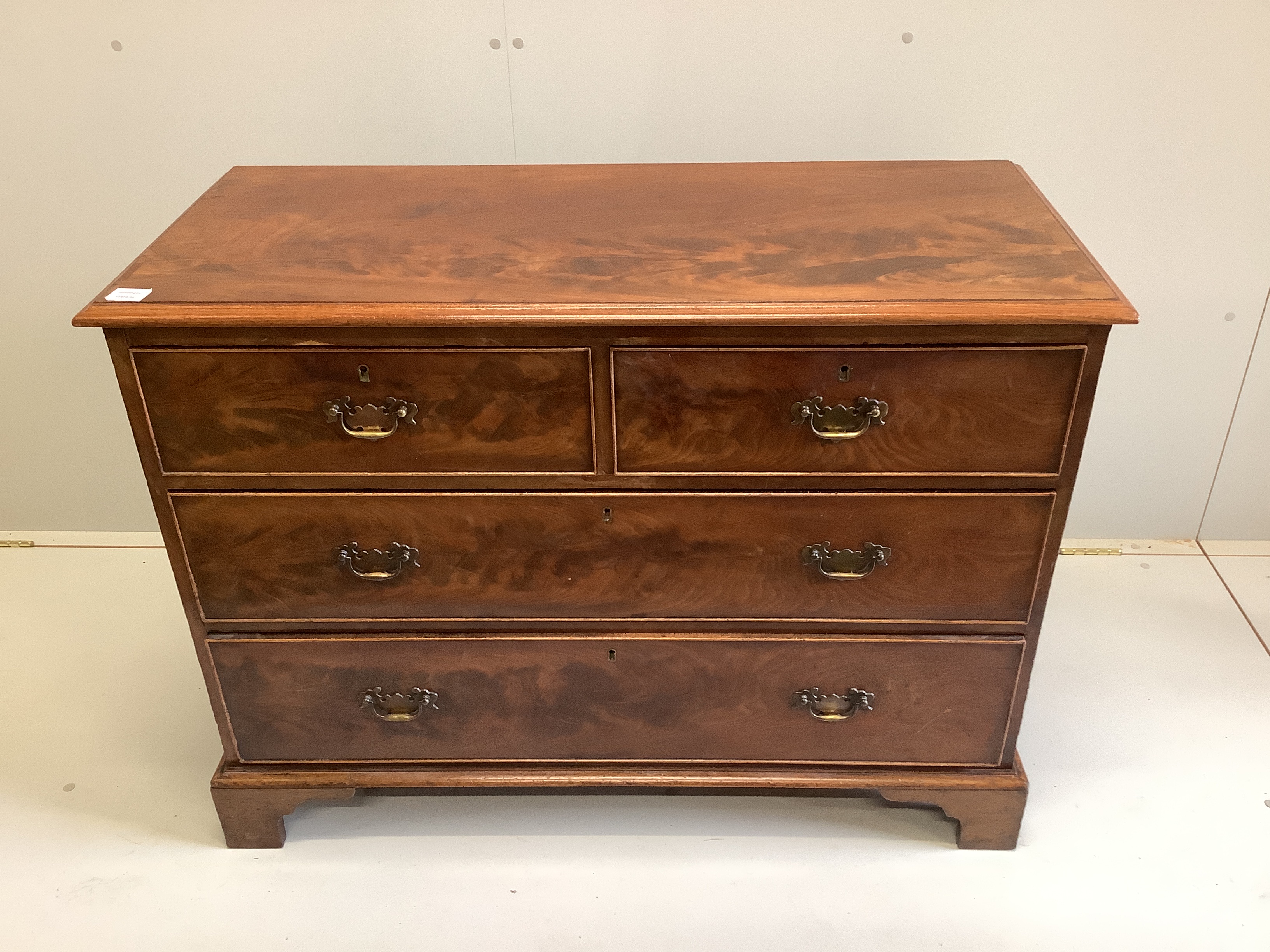 A George III mahogany chest of two short and two long drawers, raised on bracket supports, width 106cm, depth 47cm, height 79cm                                                                                             