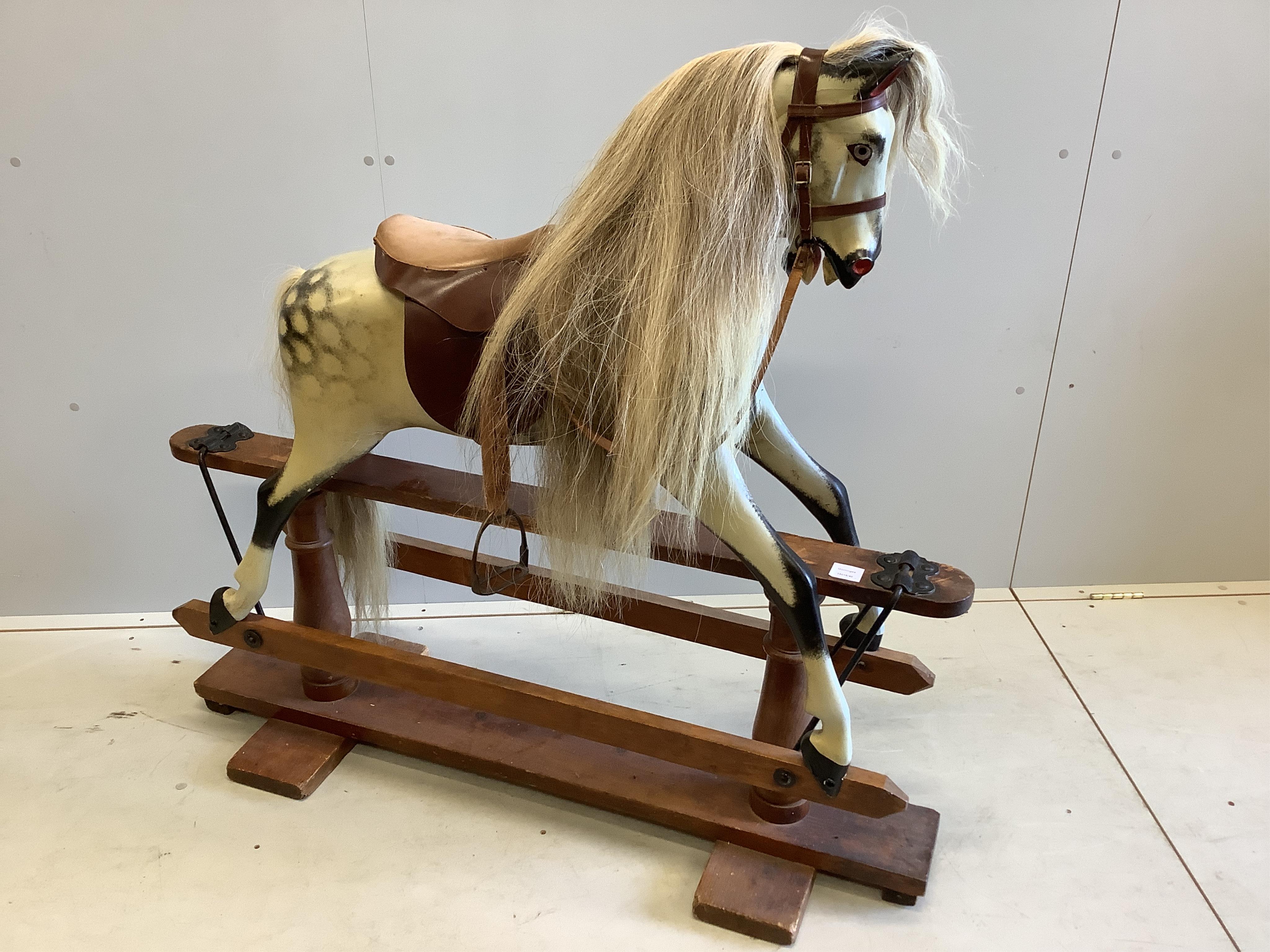 An early 20th century dapple grey rocking horse on pine safety frame, width 126cm, height 116cm. Condition - fair-good                                                                                                      