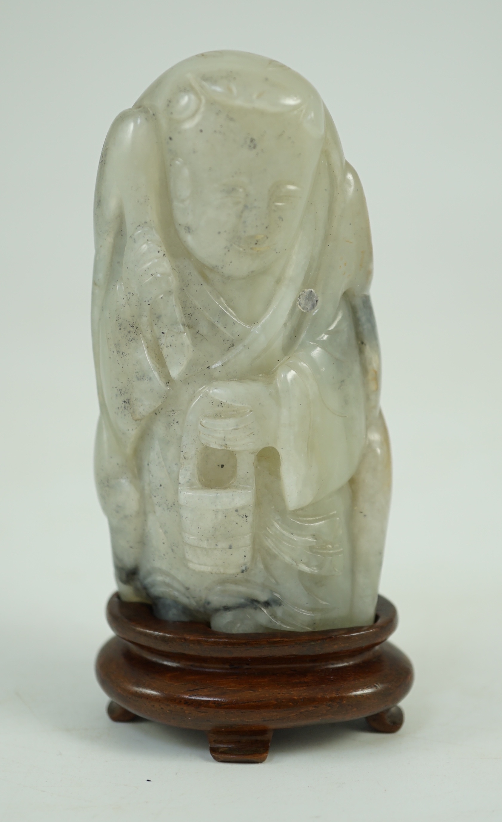 A Chinese white, grey and russet jade figure of Zhou Yanzi, Ming dynasty, 8.5cm high, Filled hole to figure, wood stand                                                                                                     