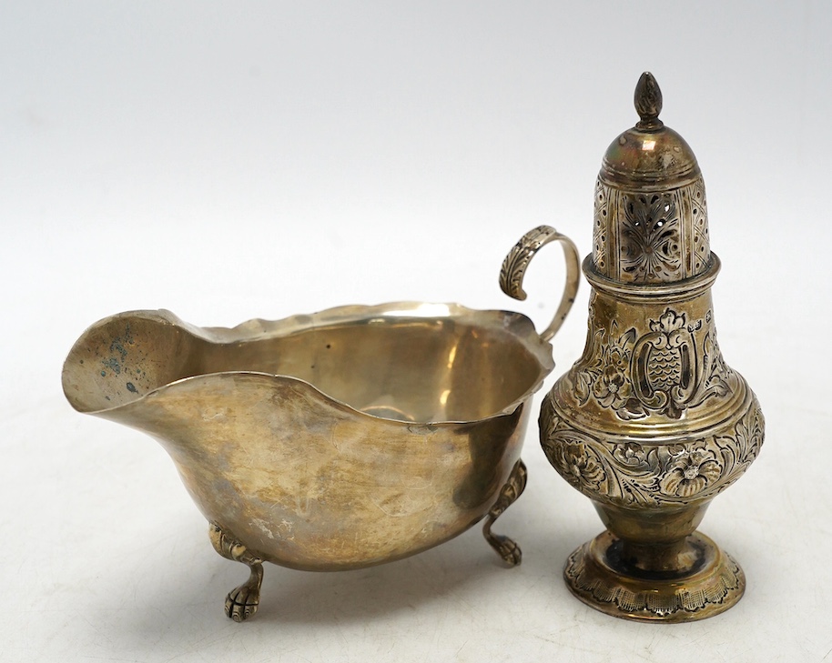 A late Victorian repousse silver pedestal sugar caster, Birmingham, 1893, 14.2cm, together with a later silver sauceboat, 6.6oz. Condition - poor to fair                                                                   