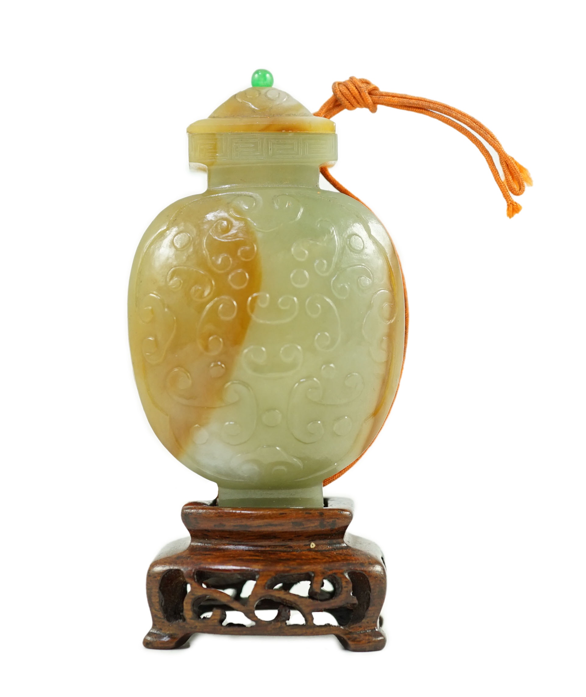 A Chinese archaistic green and russet jade miniature vase and cover, fanghu, 19th century, 6.7 cm high, foot re-carved, wood stand                                                                                          