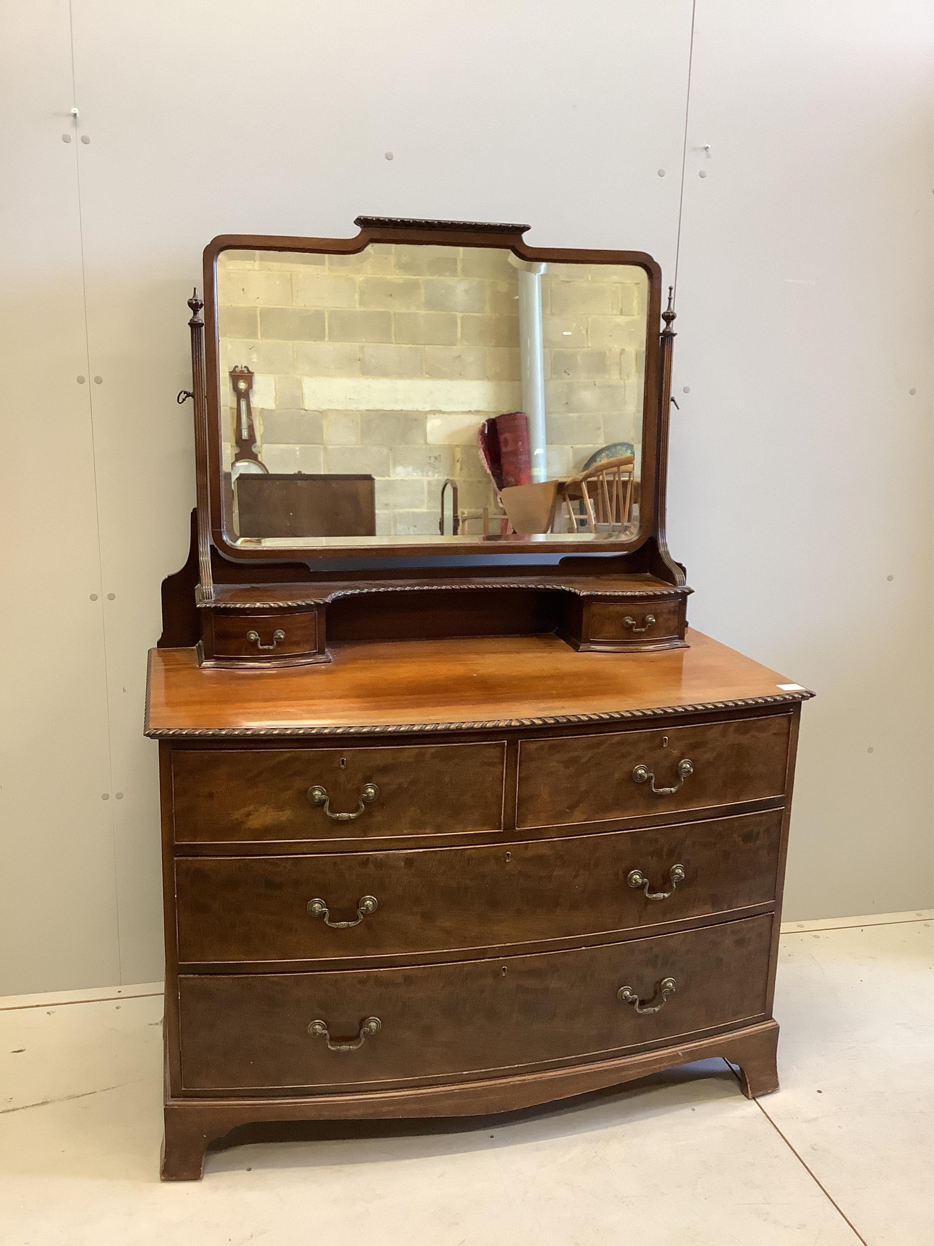 An early 20th century mahogany bow front dressing chest, width 116cm, depth 56cm, height 164cm. Condition - fair                                                                                                            