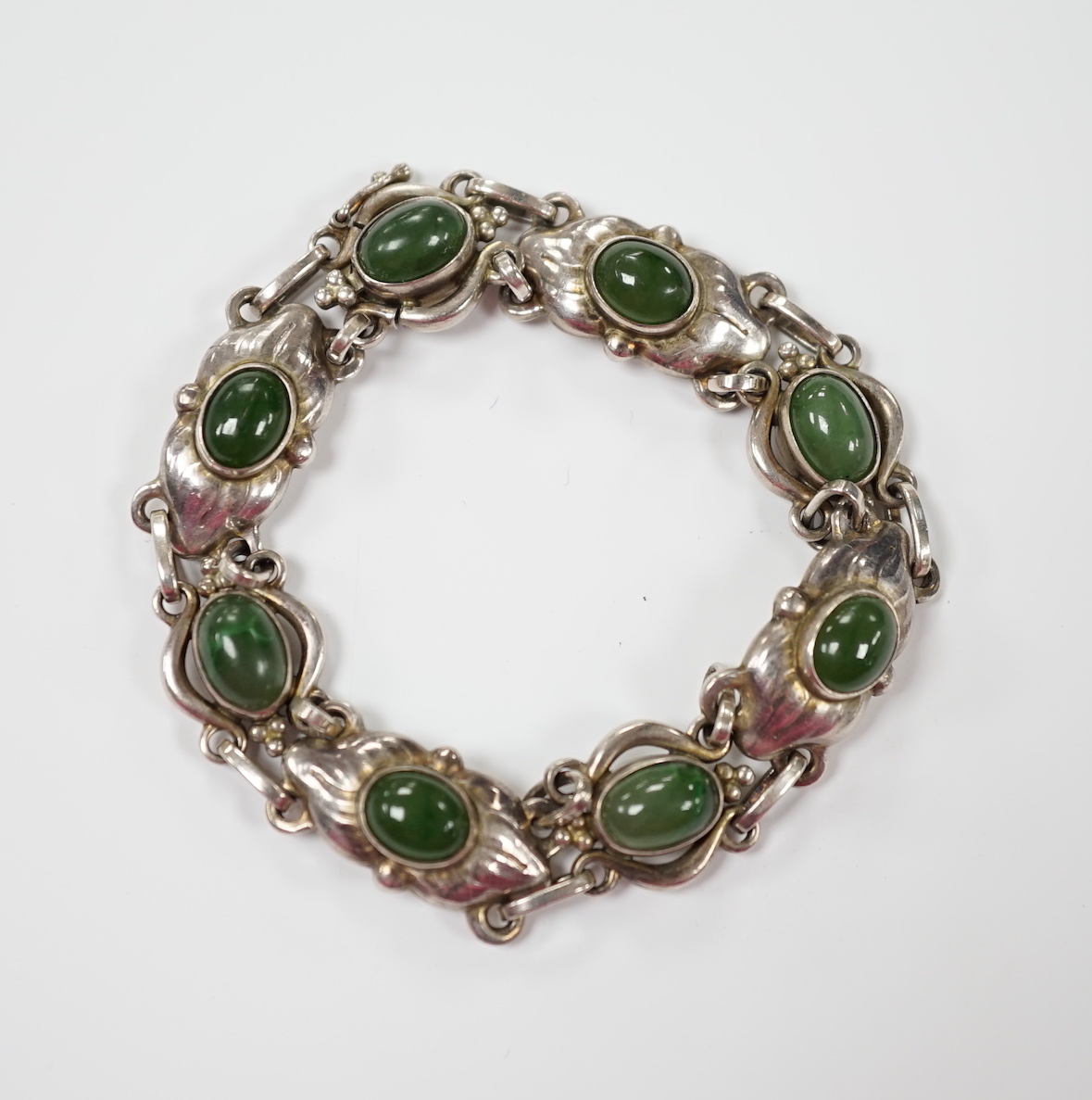 A 1970's Georg Jensen silver and cabochon nephrite set bracelet, design no.16, 18cm.                                                                                                                                        