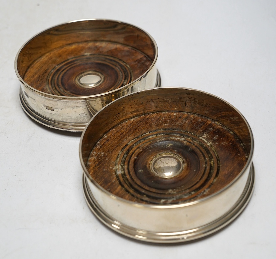 A modern pair of silver mounted wine coasters, London, 1996, diameter 12.7cm. Condition - fair to good                                                                                                                      