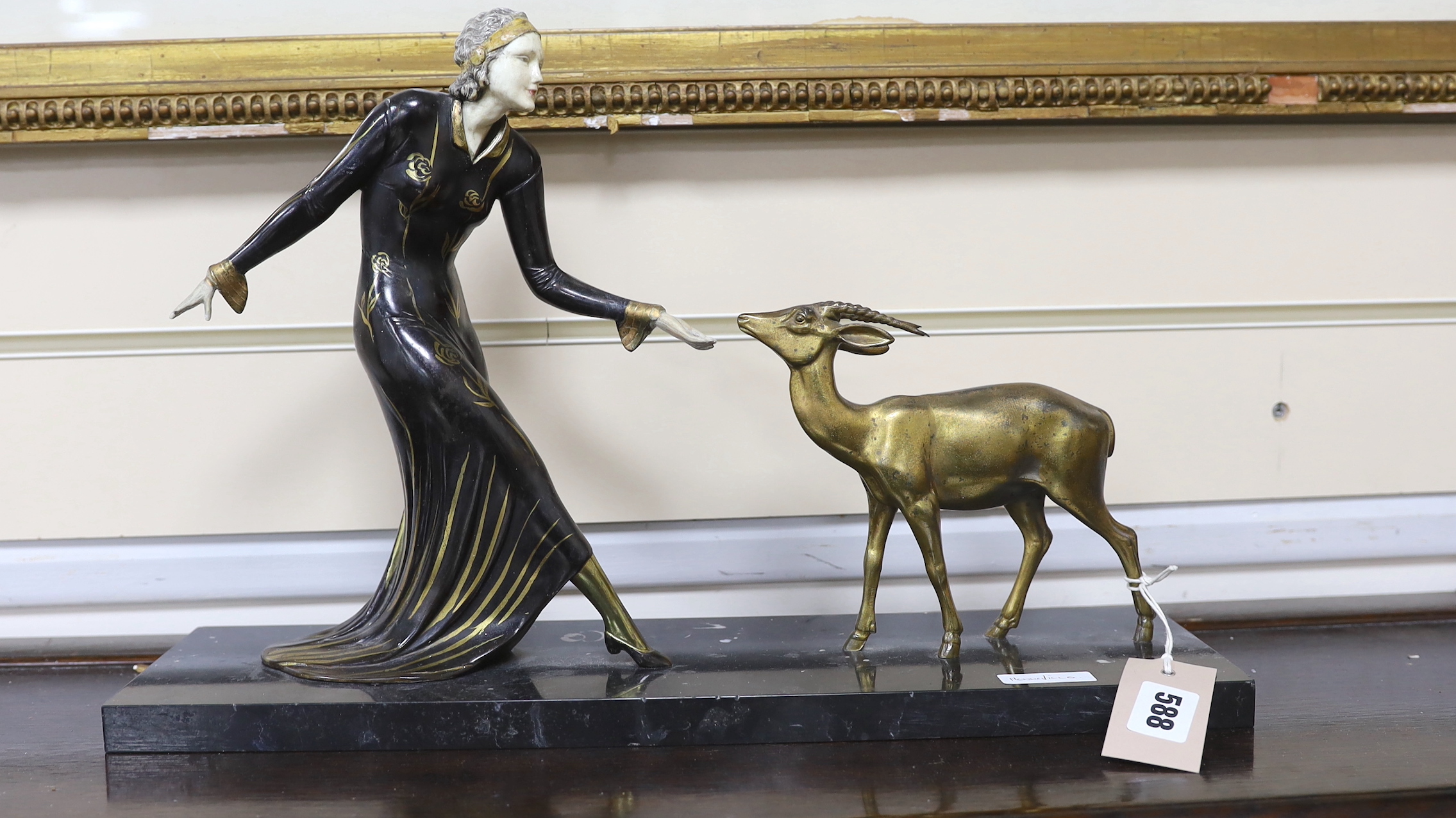 Manner of Menneville. A French Art Deco bronze of a lady feeding a fawn, 45cm wide                                                                                                                                          