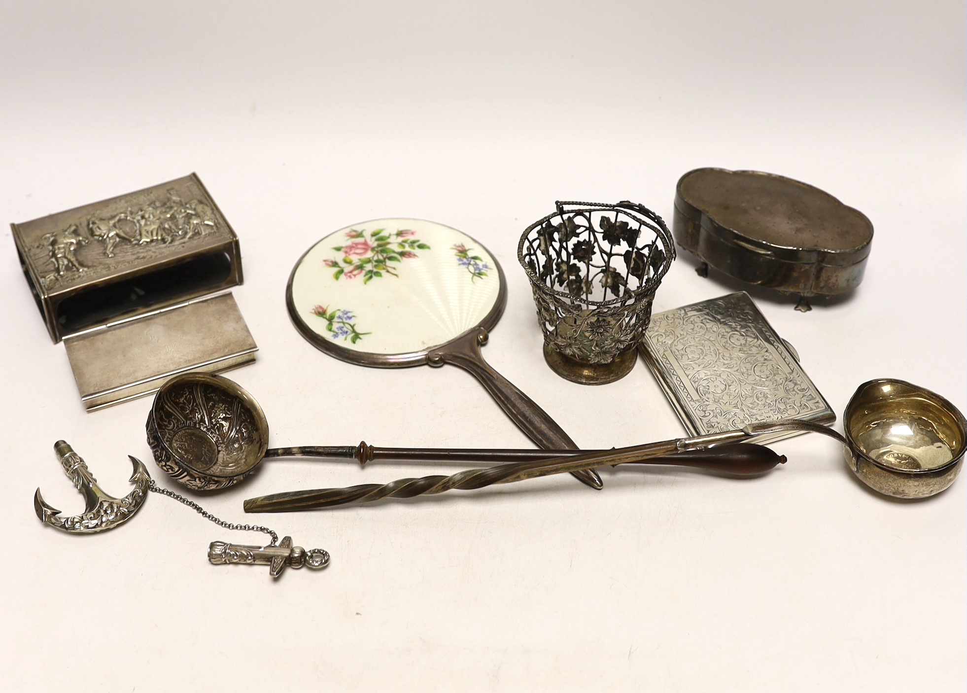 A group of assorted silver and white metal items including a George V trinket box, cigarette case, sterling stamp box, Dutch matchbox holder, George V sugar basket by William Comyns (no liner), two toddy ladles and two o