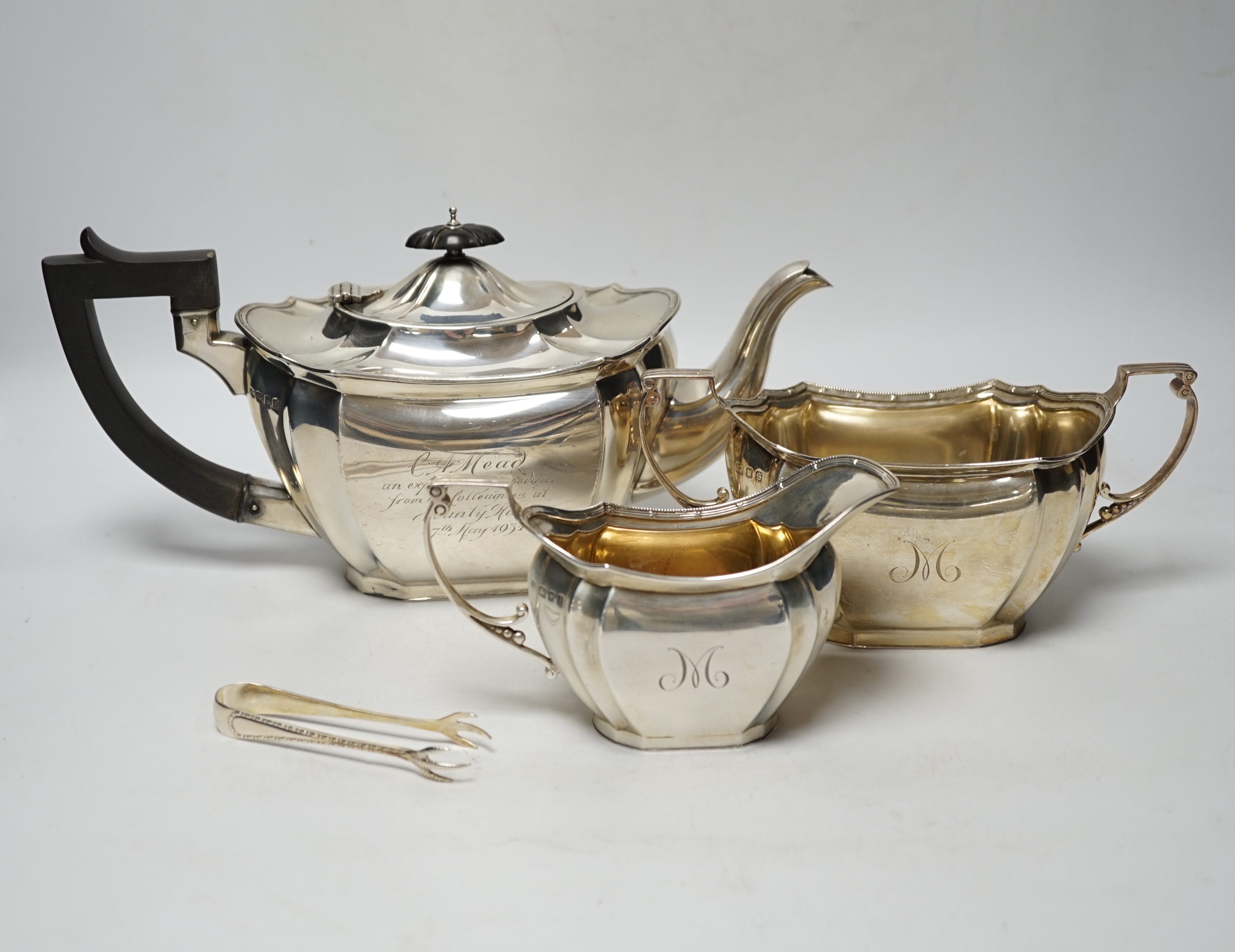 A George V three piece silver tea set by Robert Pringle & Sons, London, 1933, with engraved inscription, together with a pair of associated silver sugar tongs, gross weight 40.7oz.                                        