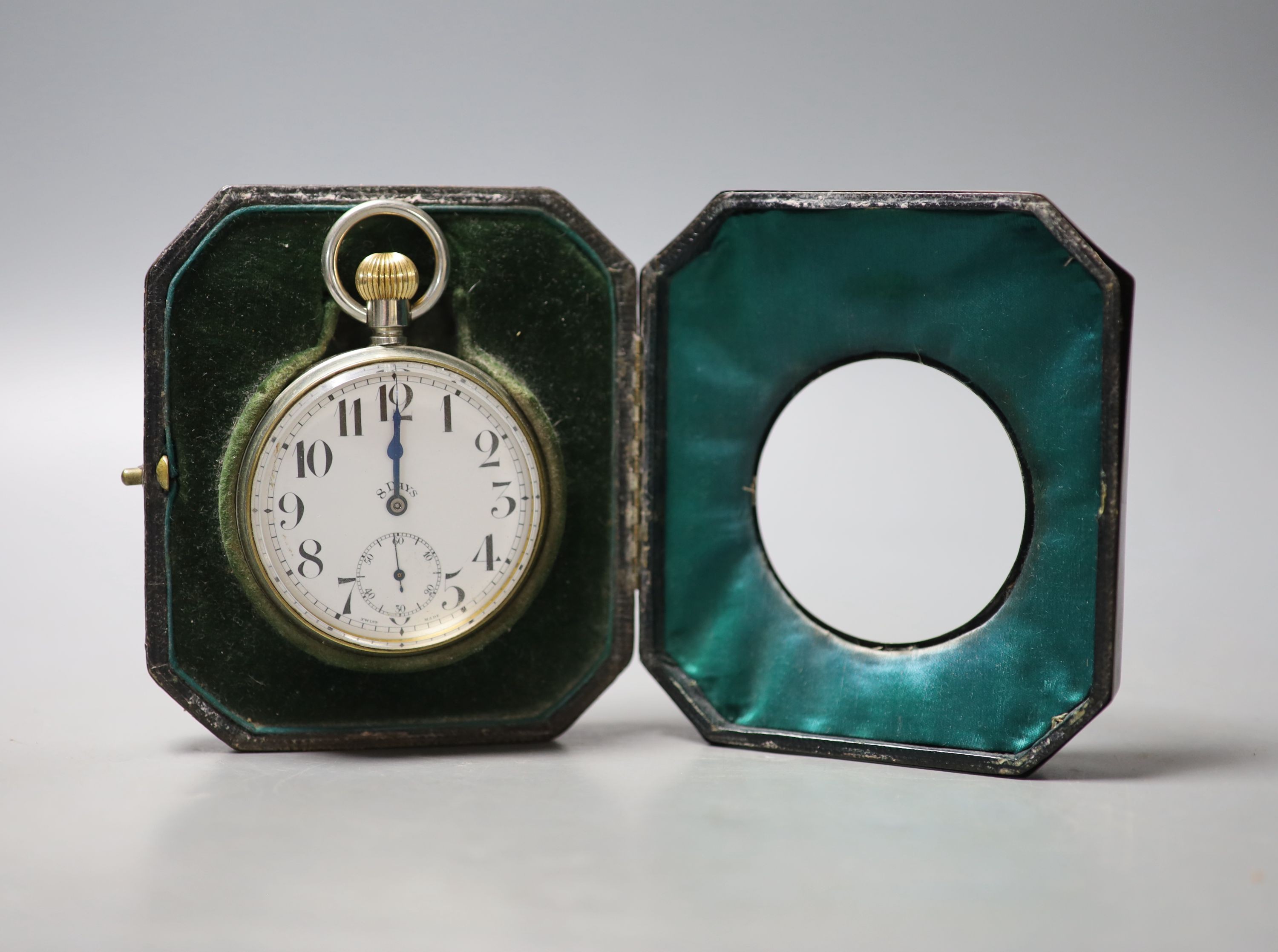 A George V engine turned silver mounted travelling watch case, with nickel cased 8 day pocket watch, 11.6cm, lacks easel.                                                                                                   