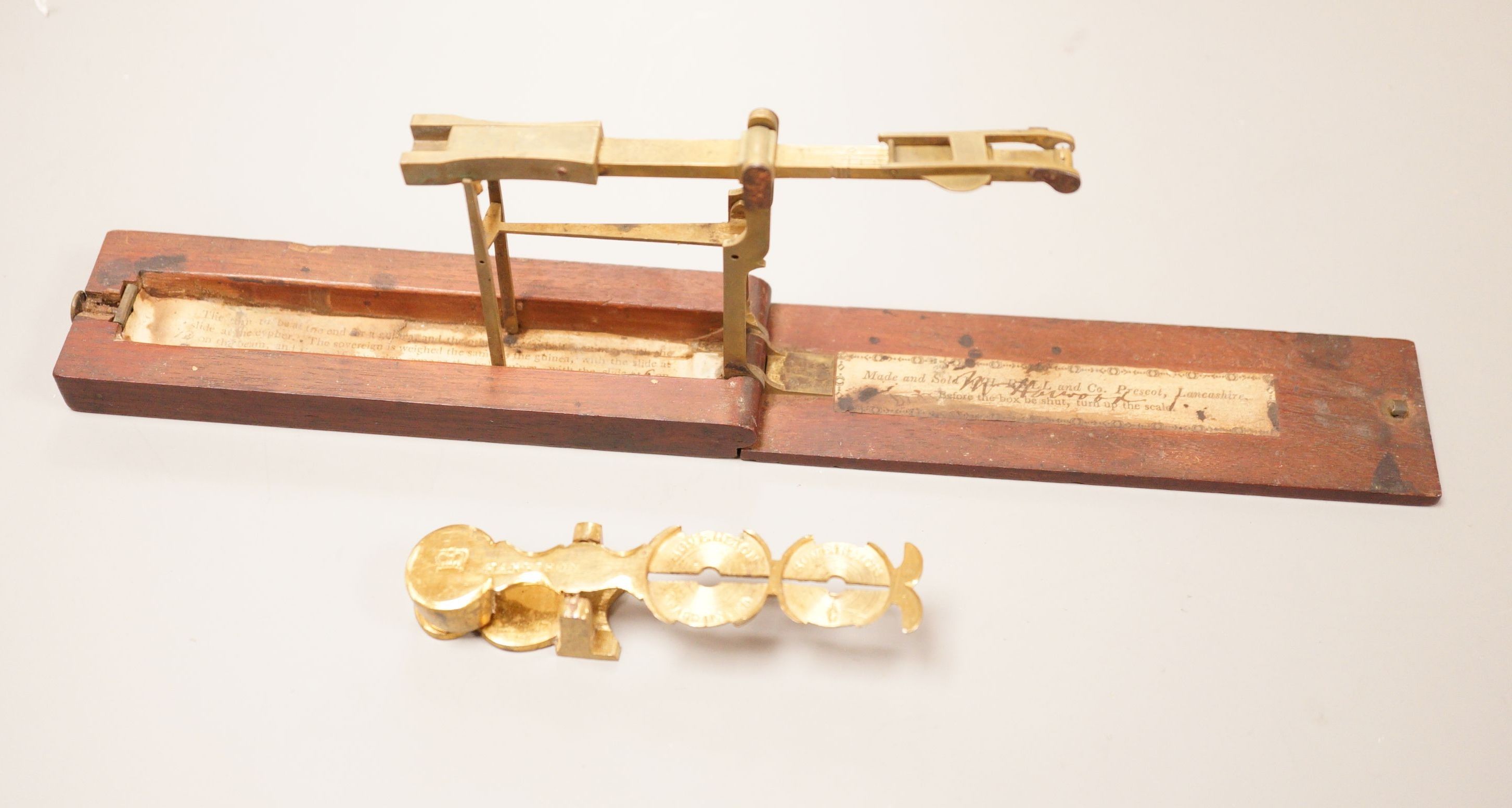 Two sets of gold / coin scales, together with a 1/2 pistol and 1 Guinea                                                                                                                                                     