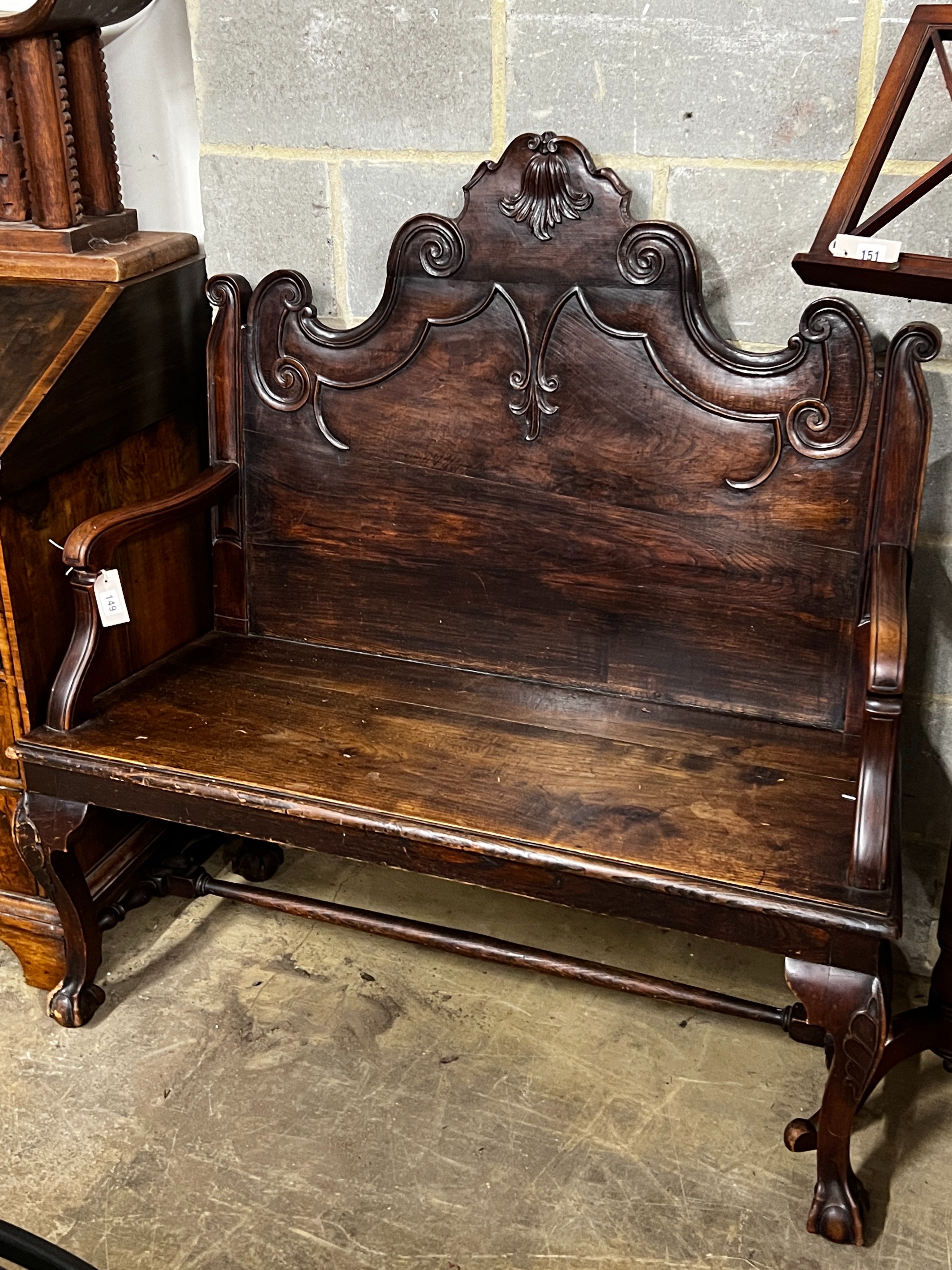 A Portuguese carved oak and fruitwood settle, width 116cm, depth 50cm, height 118cm                                                                                                                                         