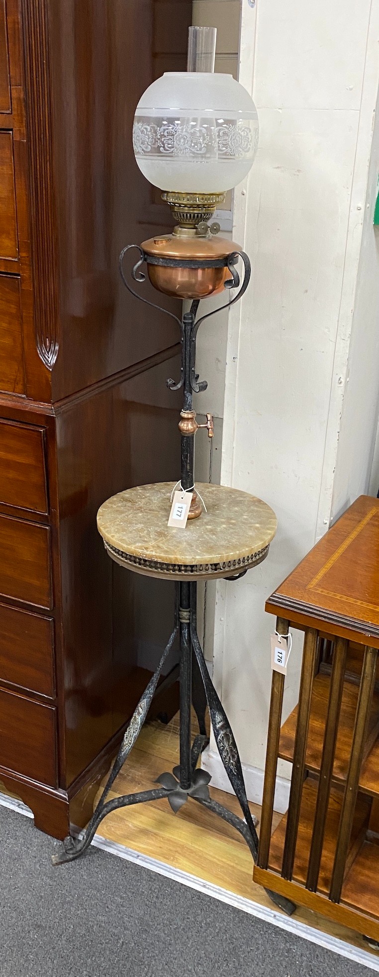 An Edwardian wrought iron and copper telescopic standard lamp with alabaster tier                                                                                                                                           