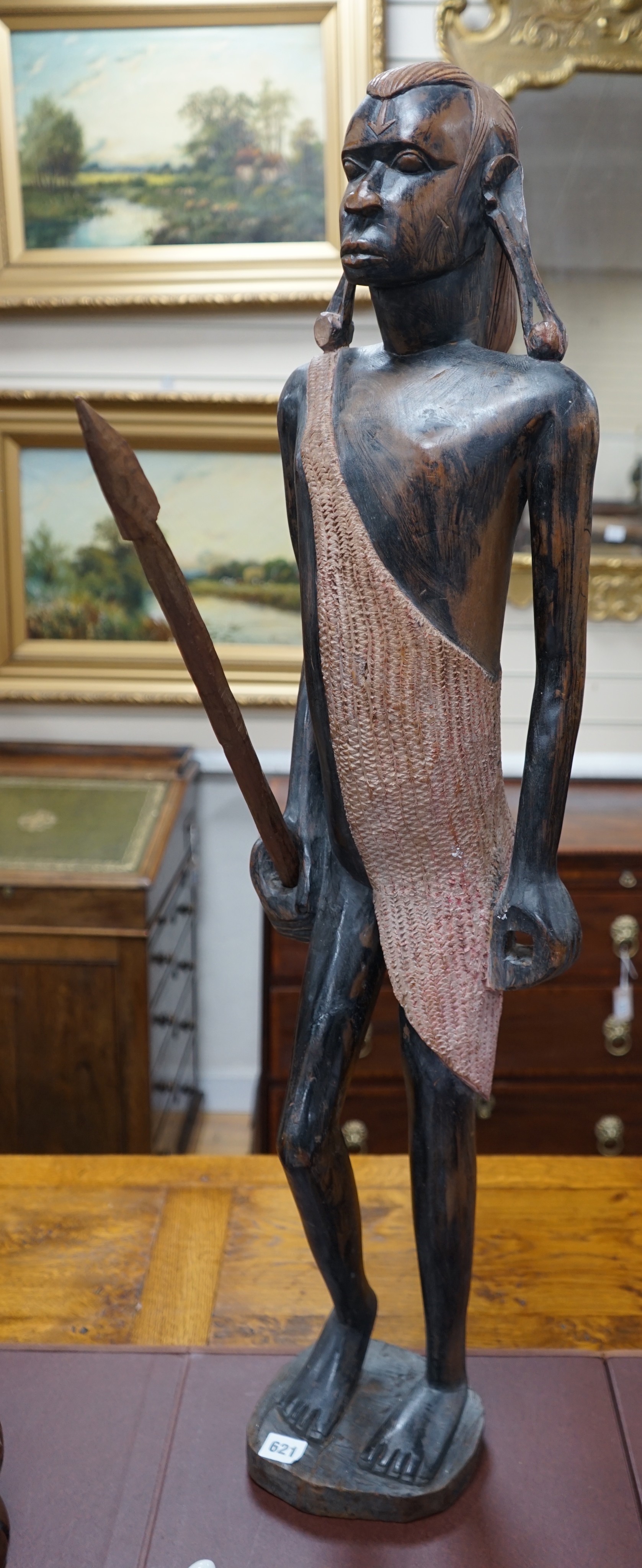A tall West African carved figure of a warrior, 100cm                                                                                                                                                                       