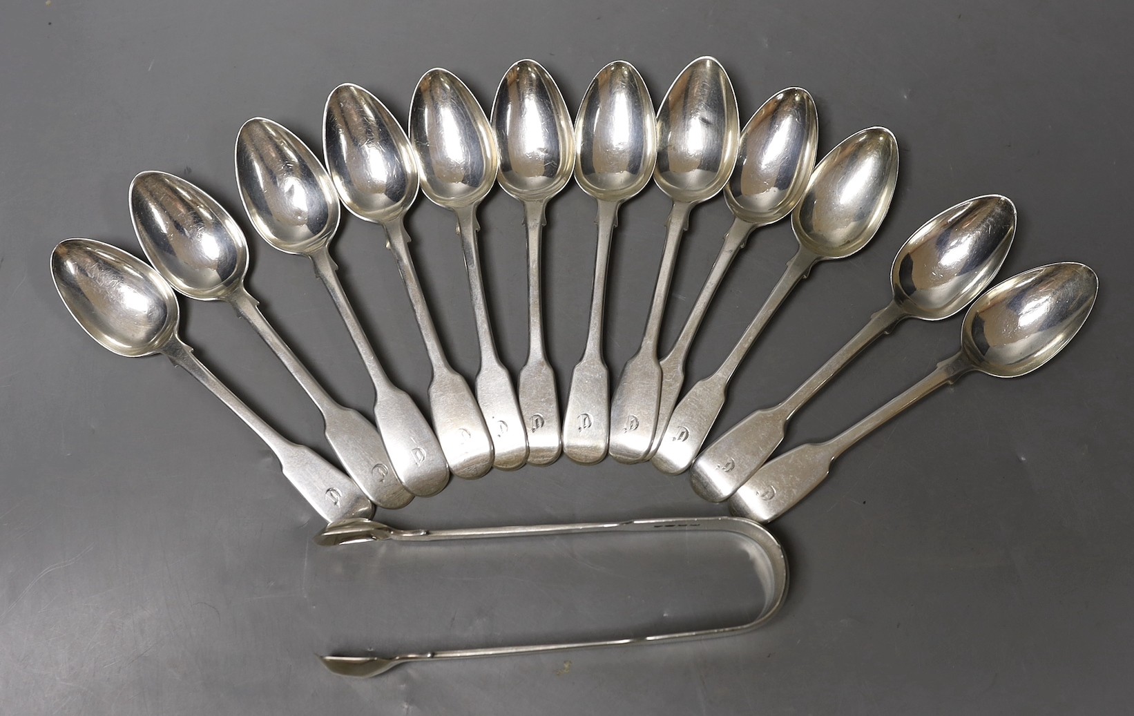 A set of six George IV silver fiddle pattern teaspoons, Eley & Fearn, London, 1820, a set of six William IV silver fiddle pattern teaspoons, J & A. Savory, London, 1836 and a pair of sugar tongs, London, 1827, 10.9oz.   