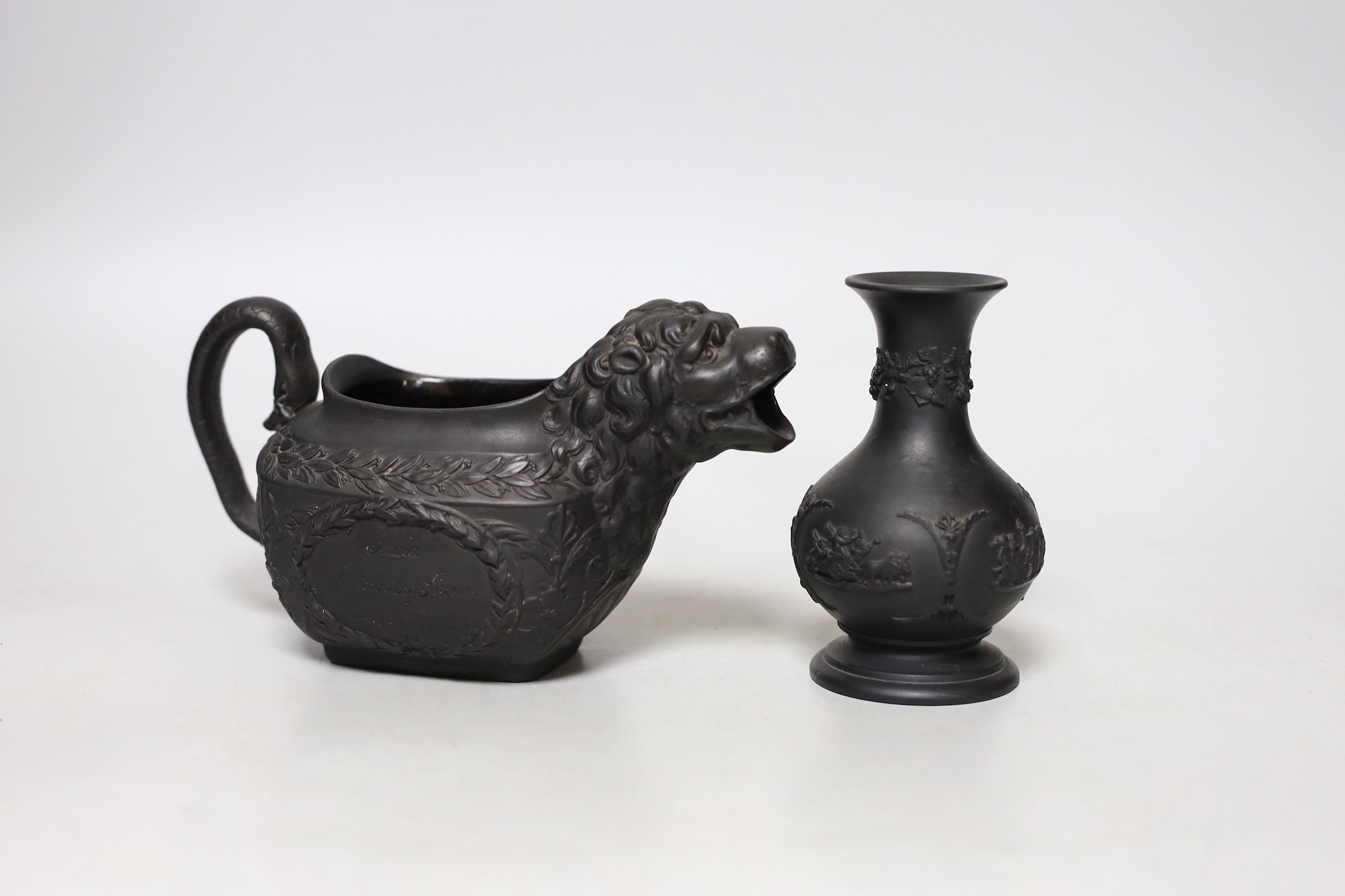 An early 19th century Wellington commemorative black basalt cream jug and a Wedgwood basalt vase                                                                                                                            