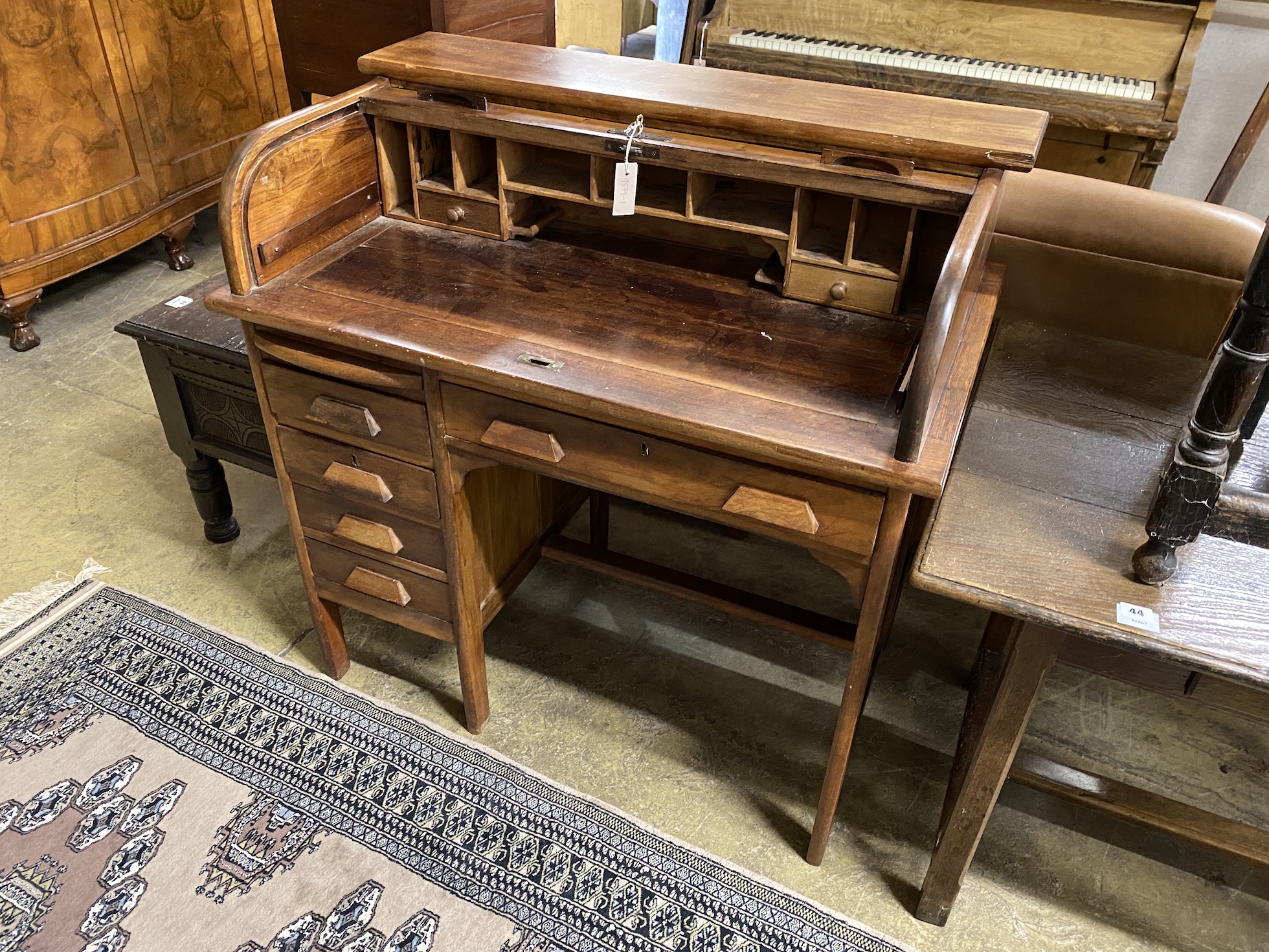 An early 20th century mahogany tambour kneehole writing desk, width 102cm, depth 62cm, height 103cm                                                                                                                         