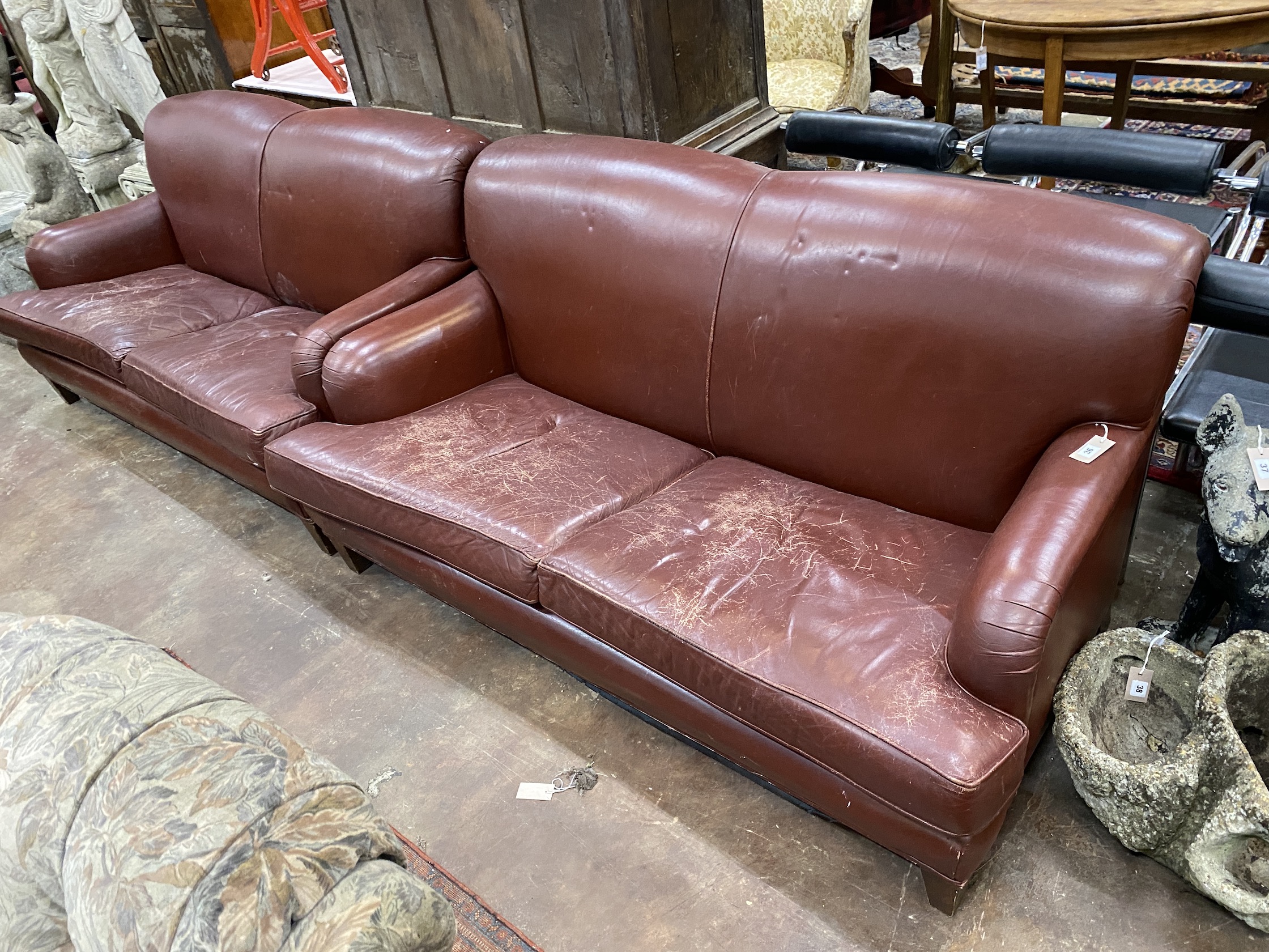 A pair of Howard style burgundy leather sofa's, width 170cm, depth 90cm, height 84cm                                                                                                                                        