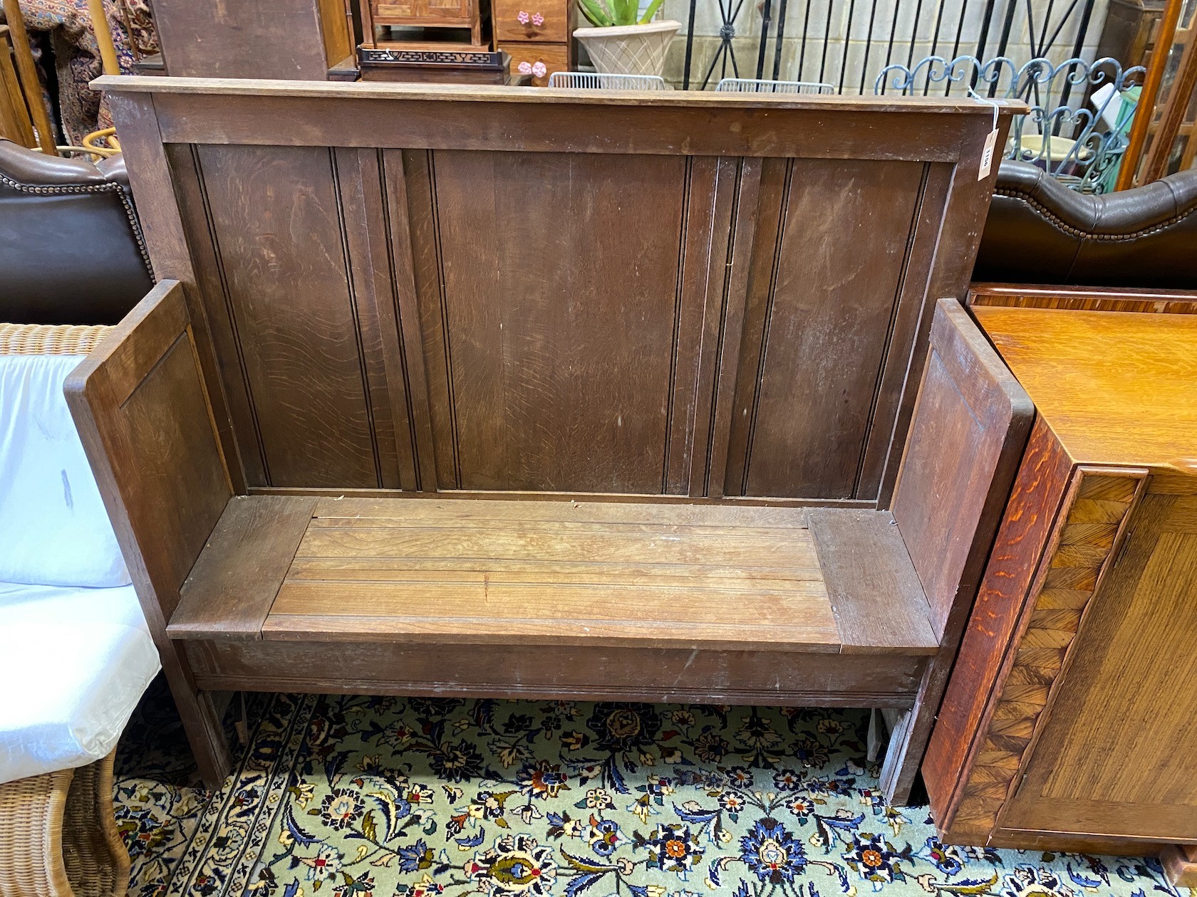 An early 20th century oak box seat settle, length 140cm, depth 39cm, height 120cm                                                                                                                                           