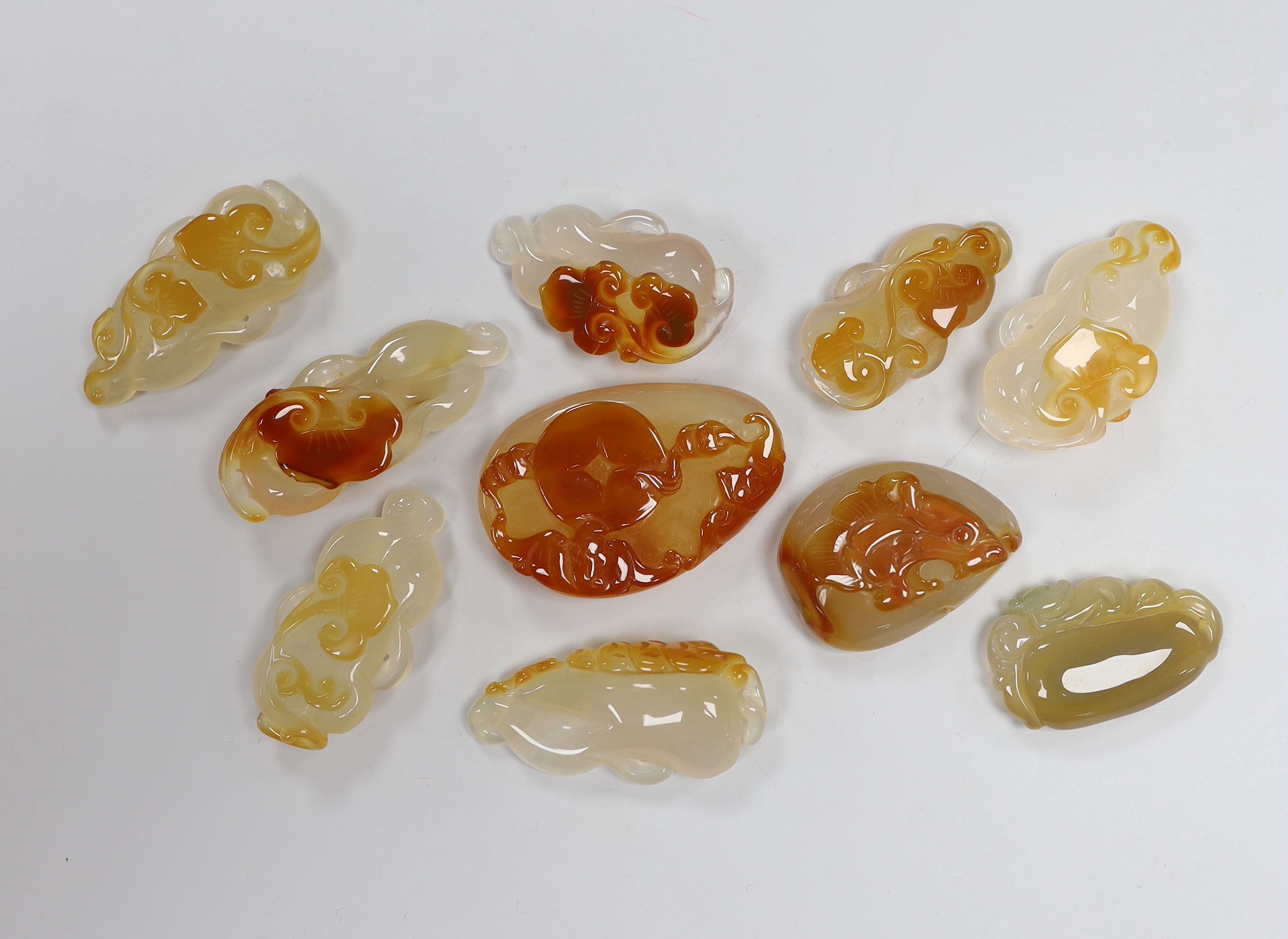 Ten Chinese agate carved pendants, the largest 6cm wide                                                                                                                                                                     