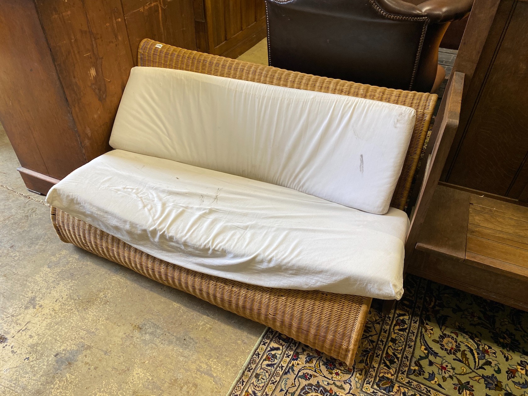 A contemporary curved cane settee, width 140cm, depth 80cm, height 72cm                                                                                                                                                     