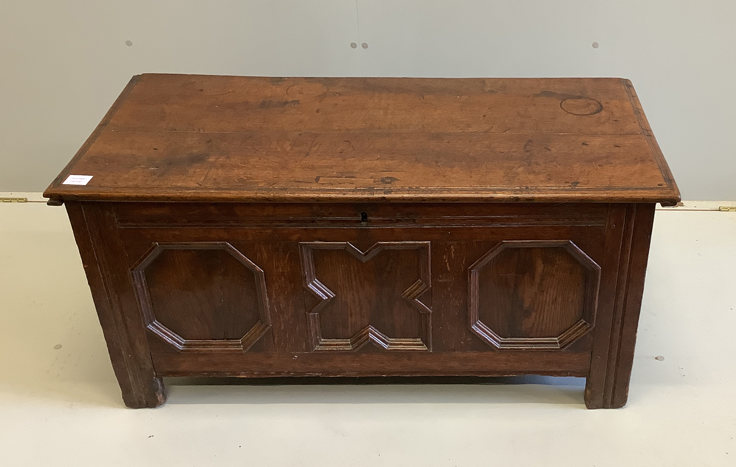 A small 17th century oak coffer with moulded geometric panelled front, width 108cm, depth 49cm, height 52cm                                                                                                                 