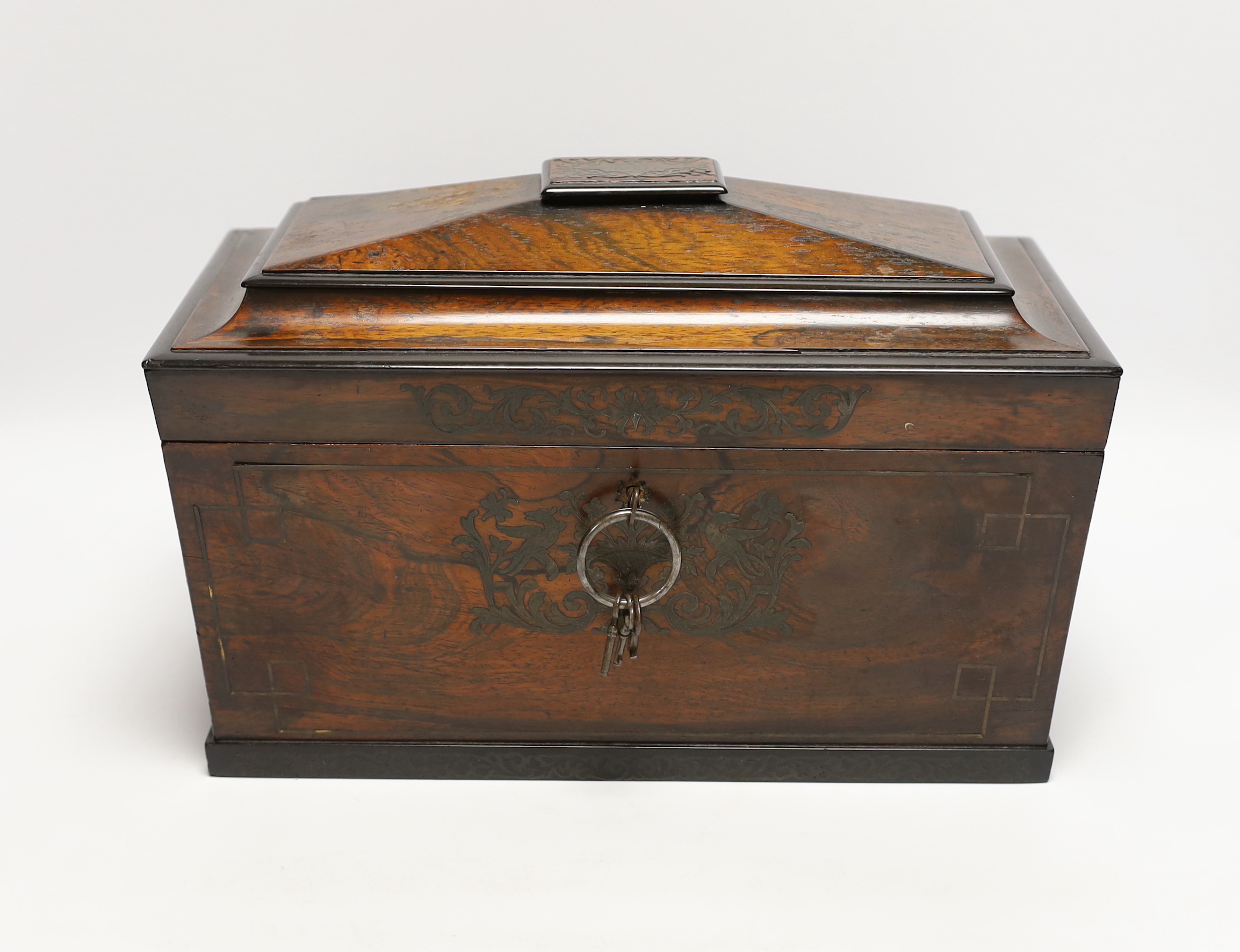 A George IV cut brass inlaid rosewood sarcophagus tea caddy, with keys, 32cm wide                                                                                                                                           