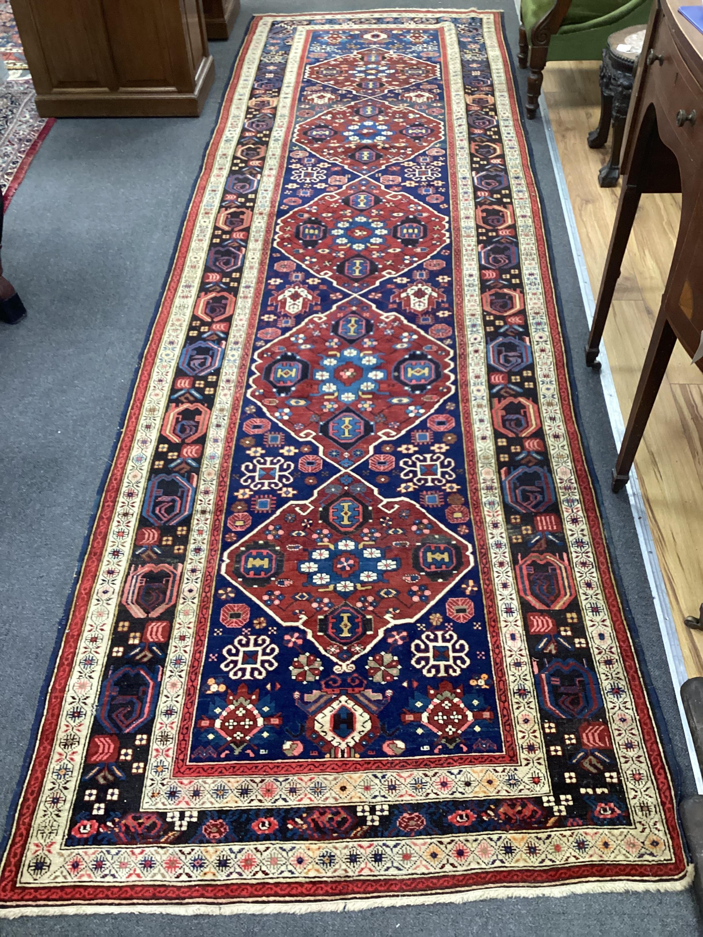 A South Caucasian blue ground runner, the field woven with five red lozenge panels, 390 x 118cm                                                                                                                             