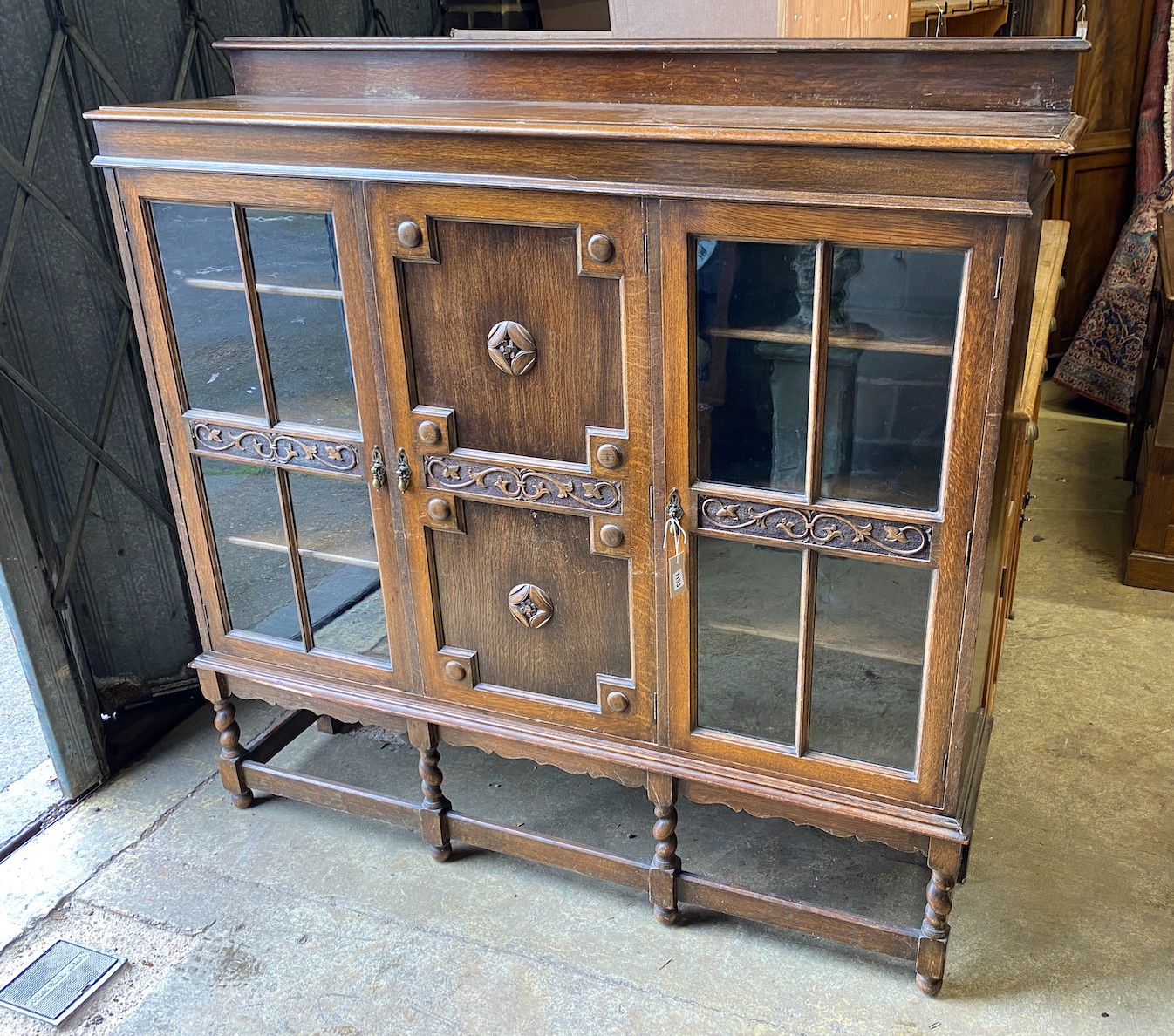 A1920's oak bookcase, length 150cm, depth 35cm, height 150cm                                                                                                                                                                
