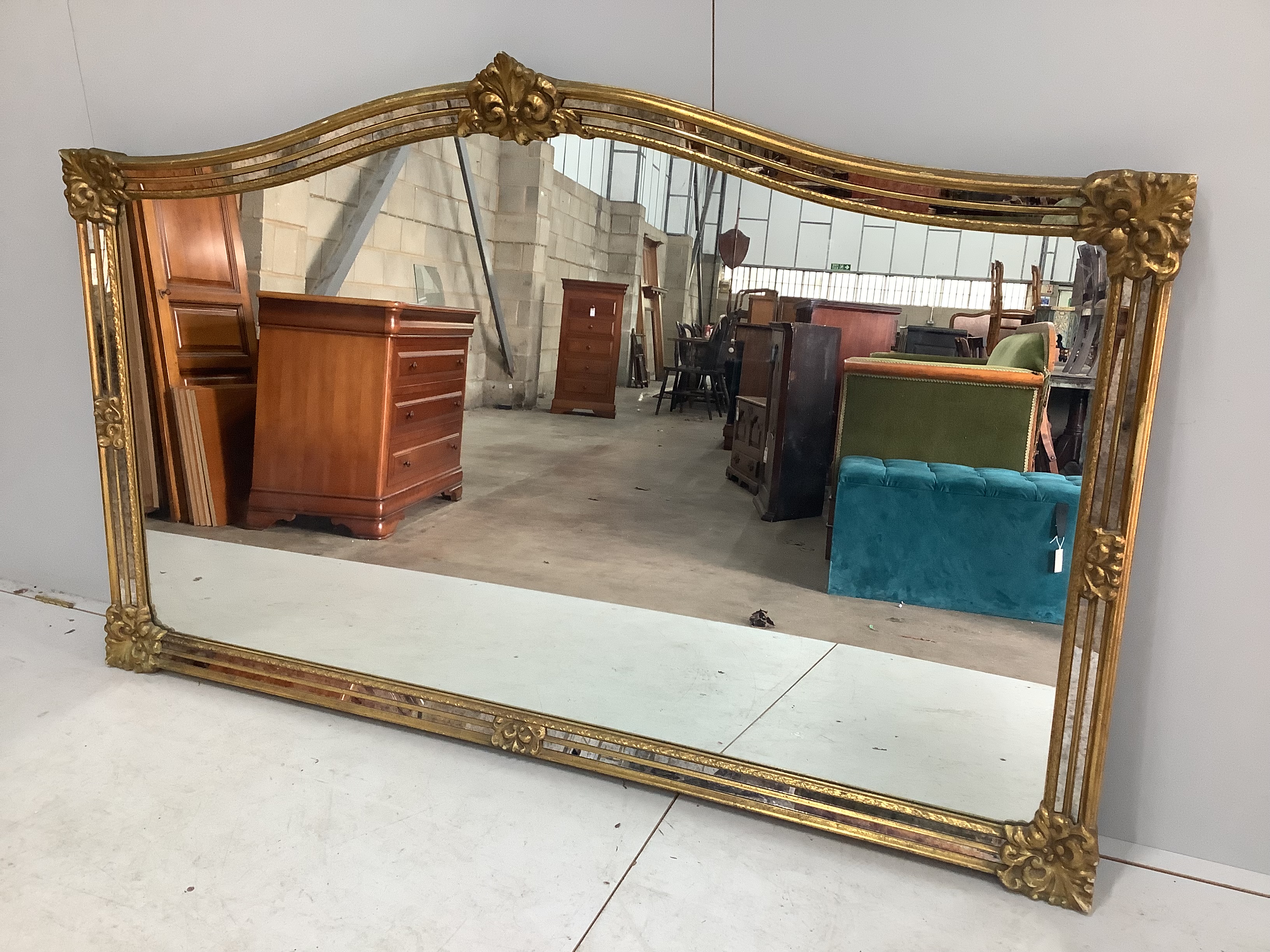 A large Victorian style gilt framed overmantel mirror, width 184cm, height 112cm                                                                                                                                            