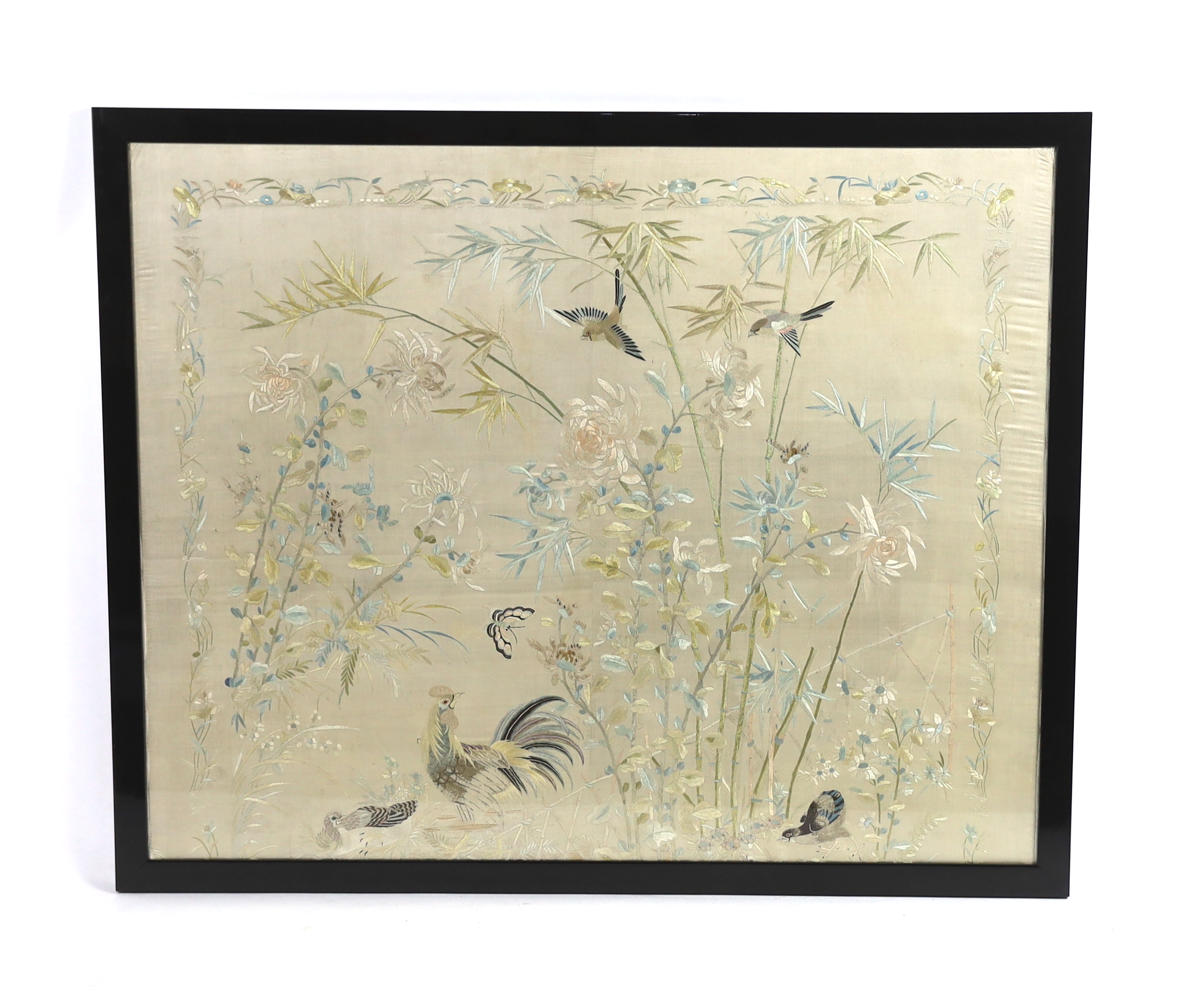 A framed early 20th century Chinese silk embroidered shawl, embroidered with chickens, ducks, flying birds and insects amongst bamboo and flowering plants, 126cm wide x 10.5cm high                                        
