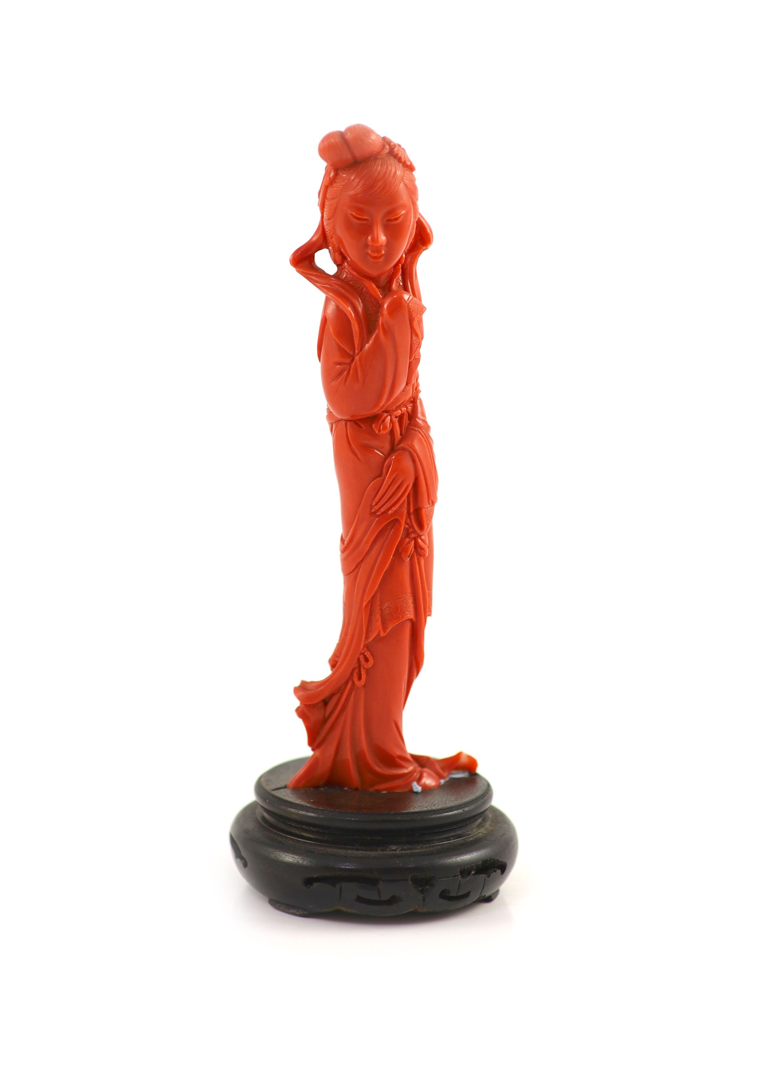 A Chinese coral figure of a tall lady, mid 20th century, 14.7 cm high, 116g, wood stand                                                                                                                                     