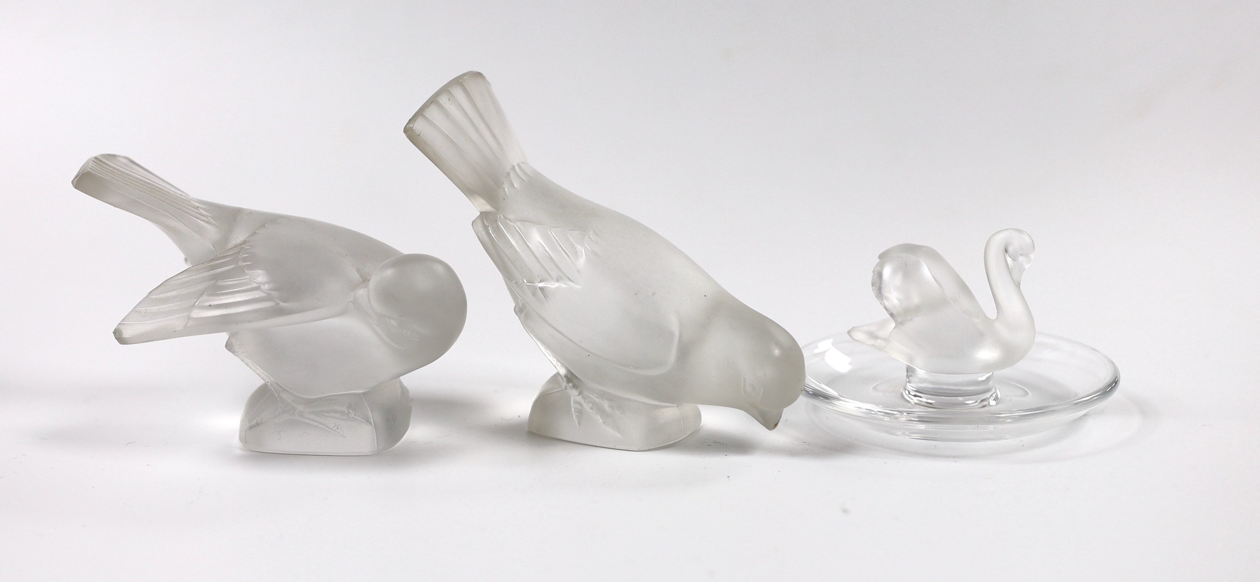 Two Lalique glass paperweights modelled as pecking birds, together with another Lalique swan modelled pin dish                                                                                                              