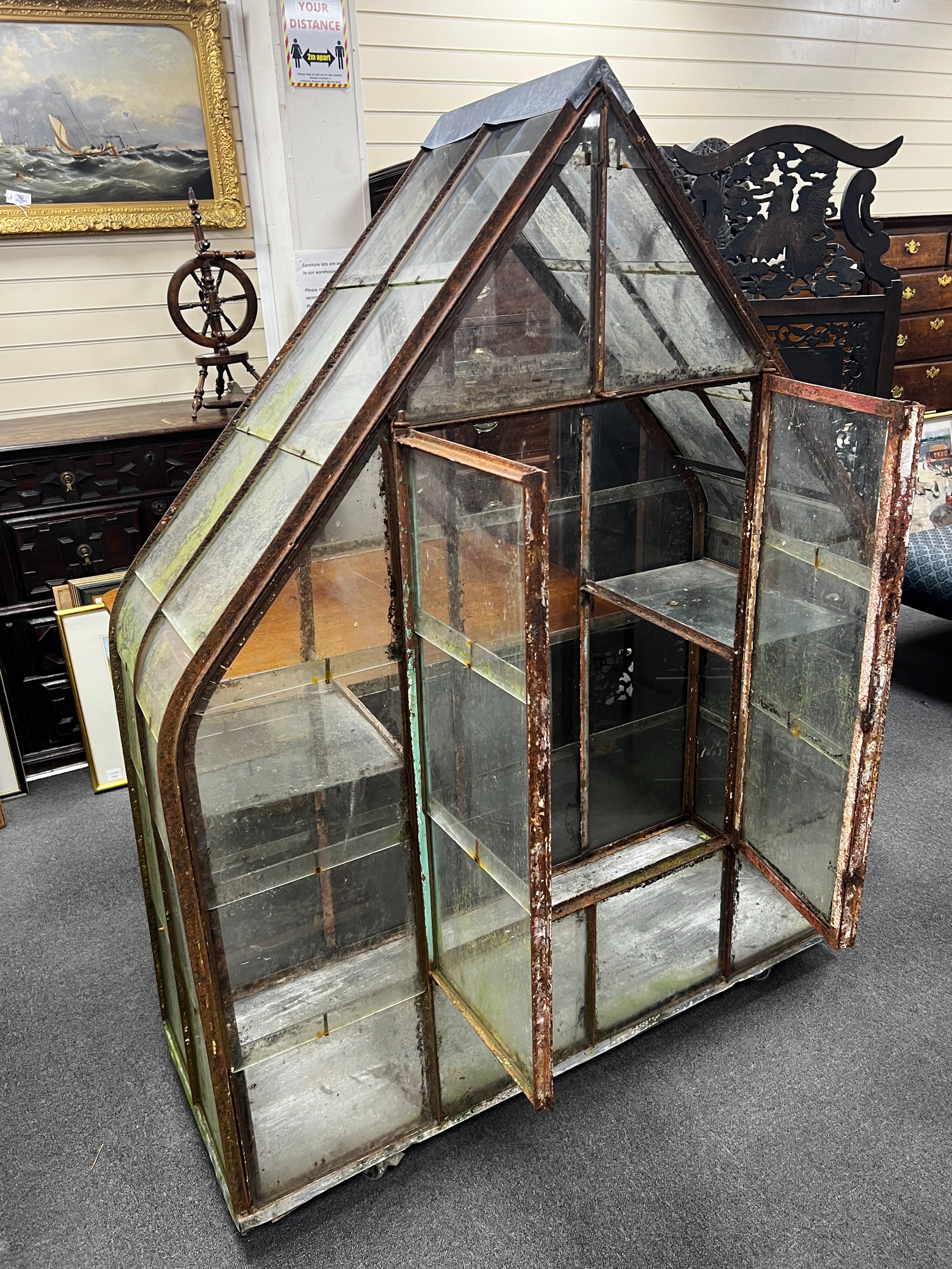 A vintage arched greenhouse on wheeled base, width 136cm, depth 51cm, height 174cm                                                                                                                                          
