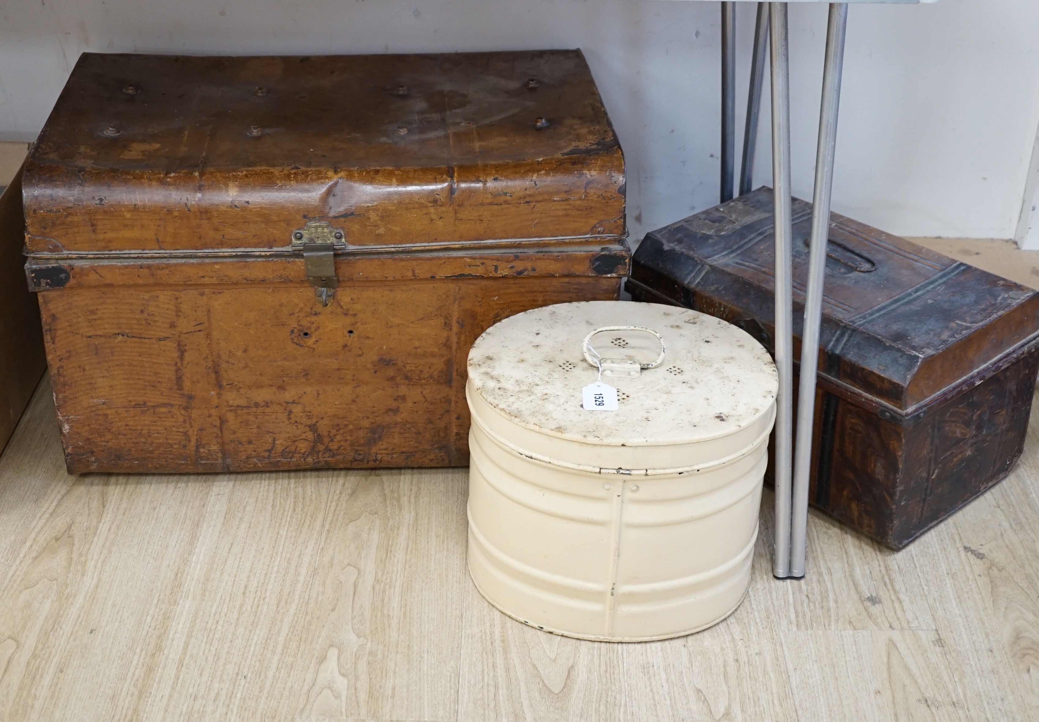 A large painted tin trunk, a smaller trunk and a cream hat tin, largest 70cm wide                                                                                                                                           