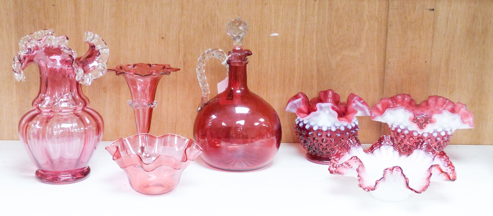 A group of Victorian Cranberry glass dishes, two vases and a Claret jug, tallest 23.5 cm (7)                                                                                                                                